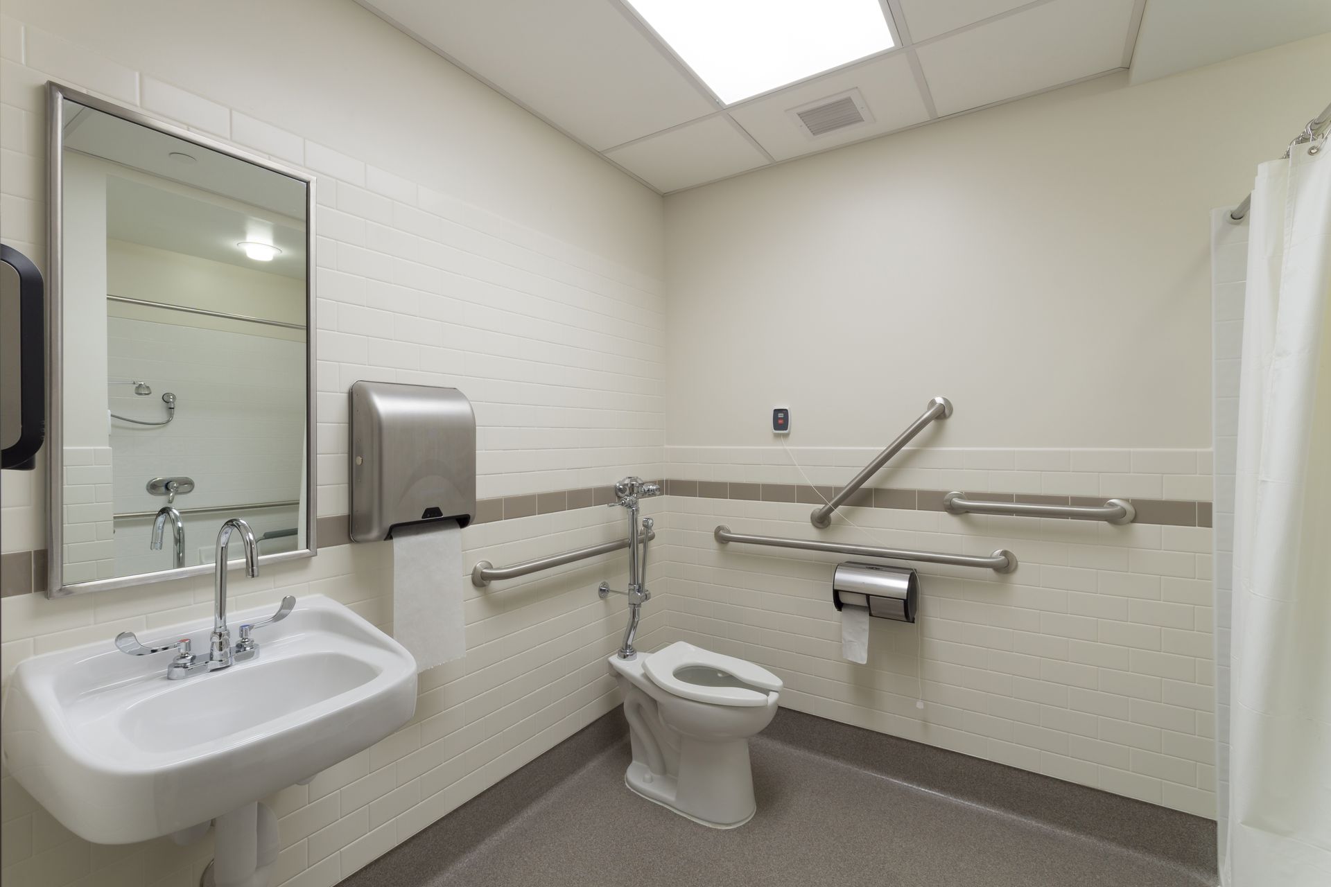 A bathroom with a toilet , sink and mirror