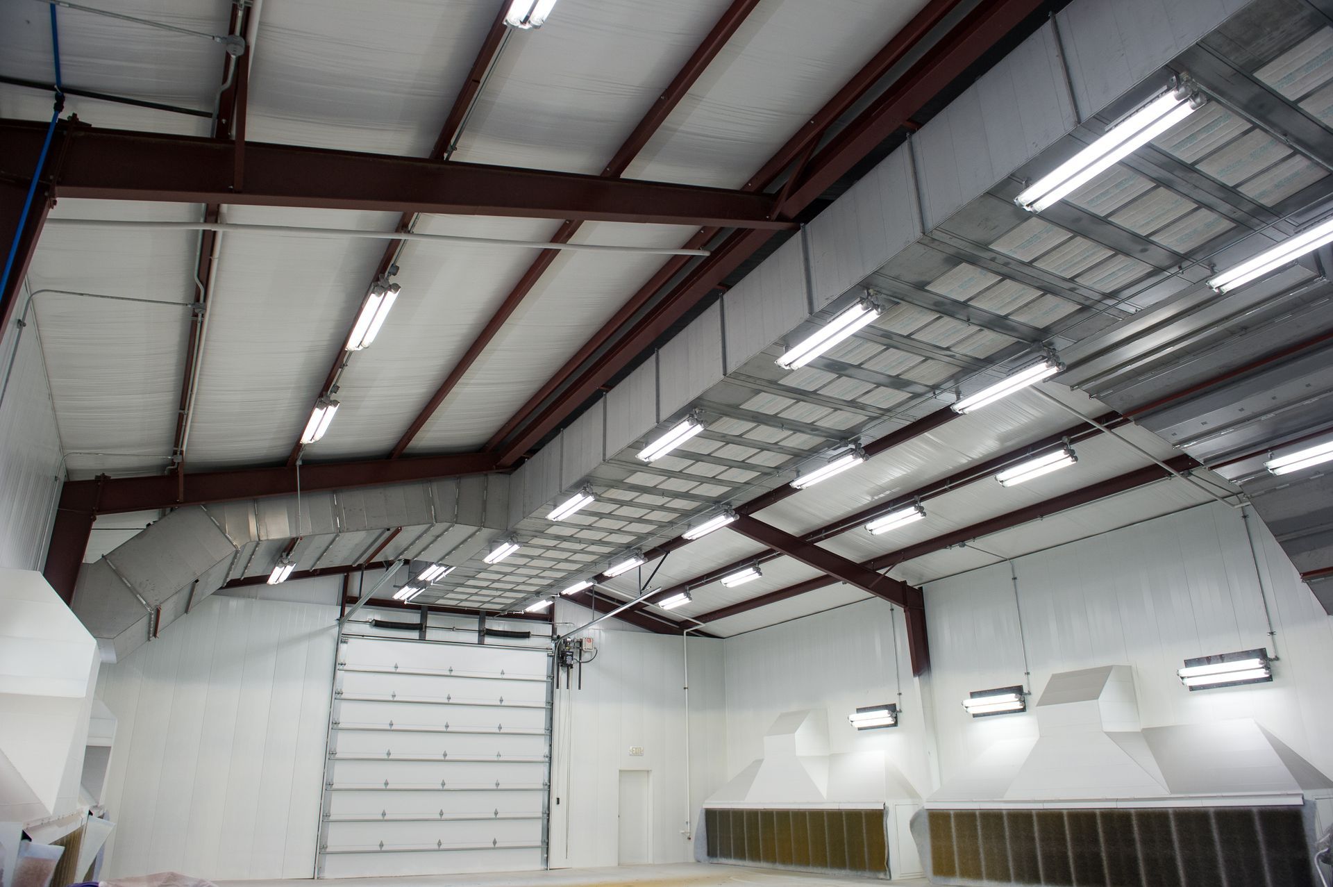 A large warehouse with lots of lights on the ceiling