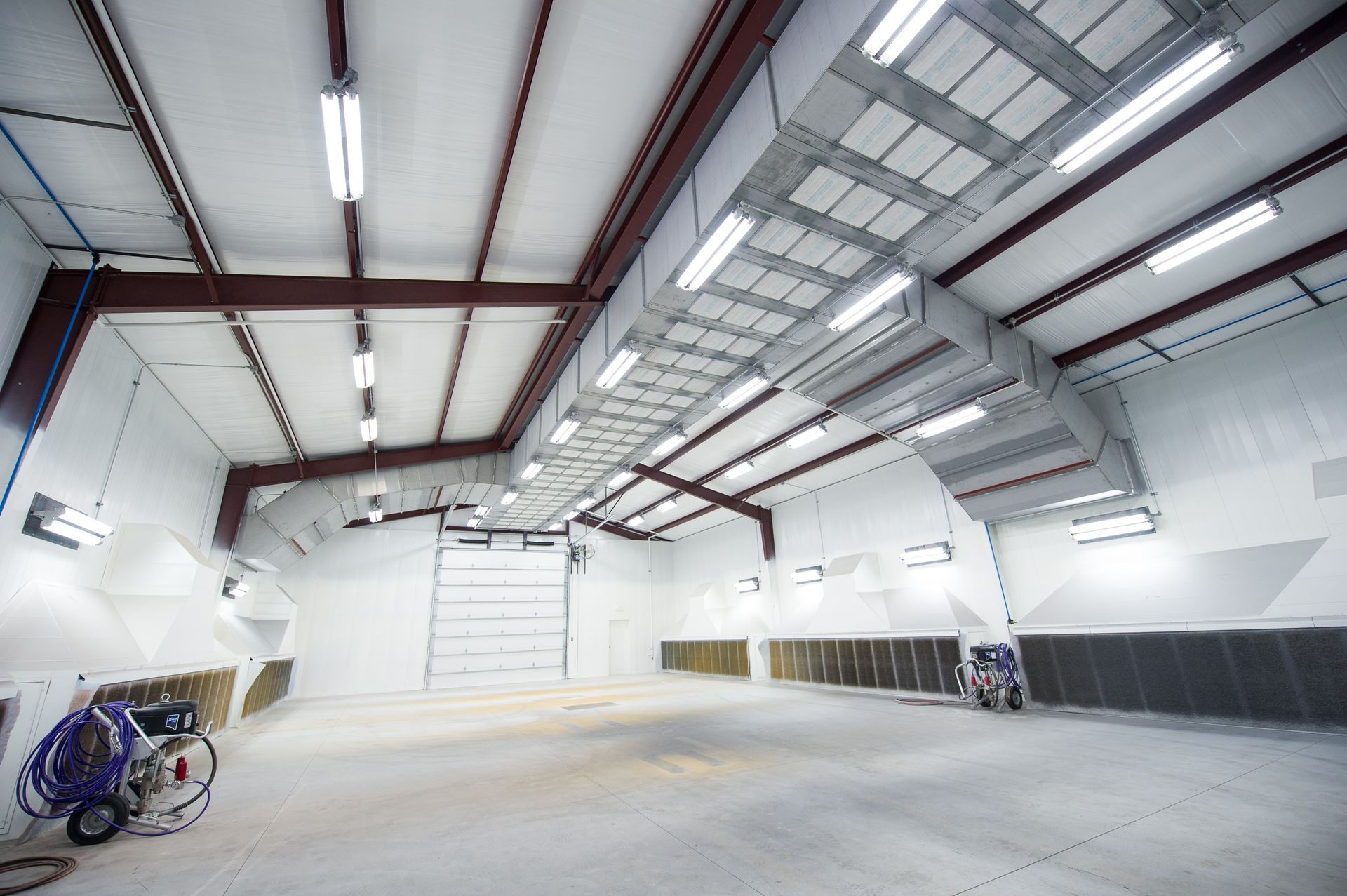 A large empty warehouse with a machine in the middle of it.