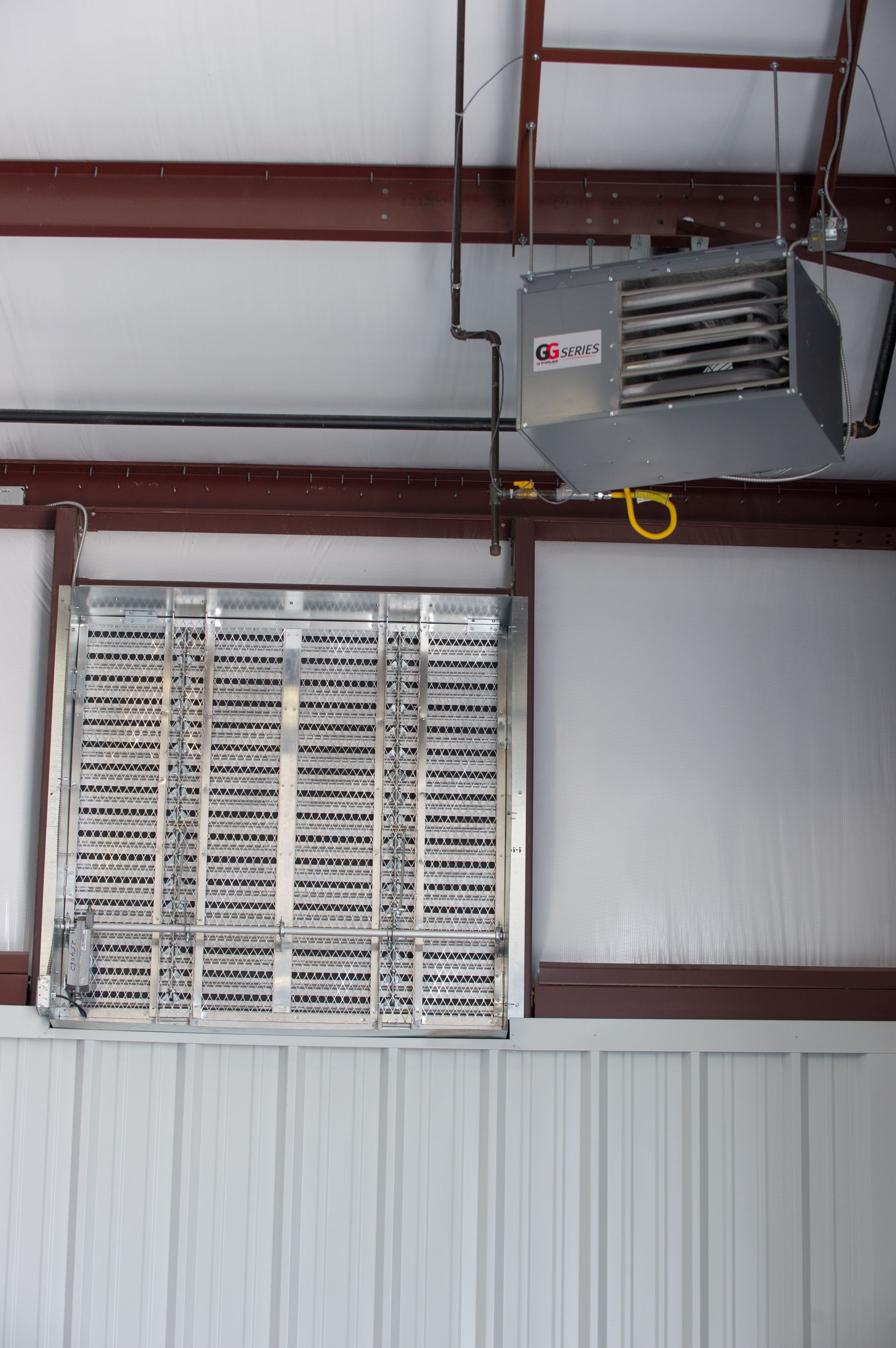 A heater is hanging from the ceiling of a building