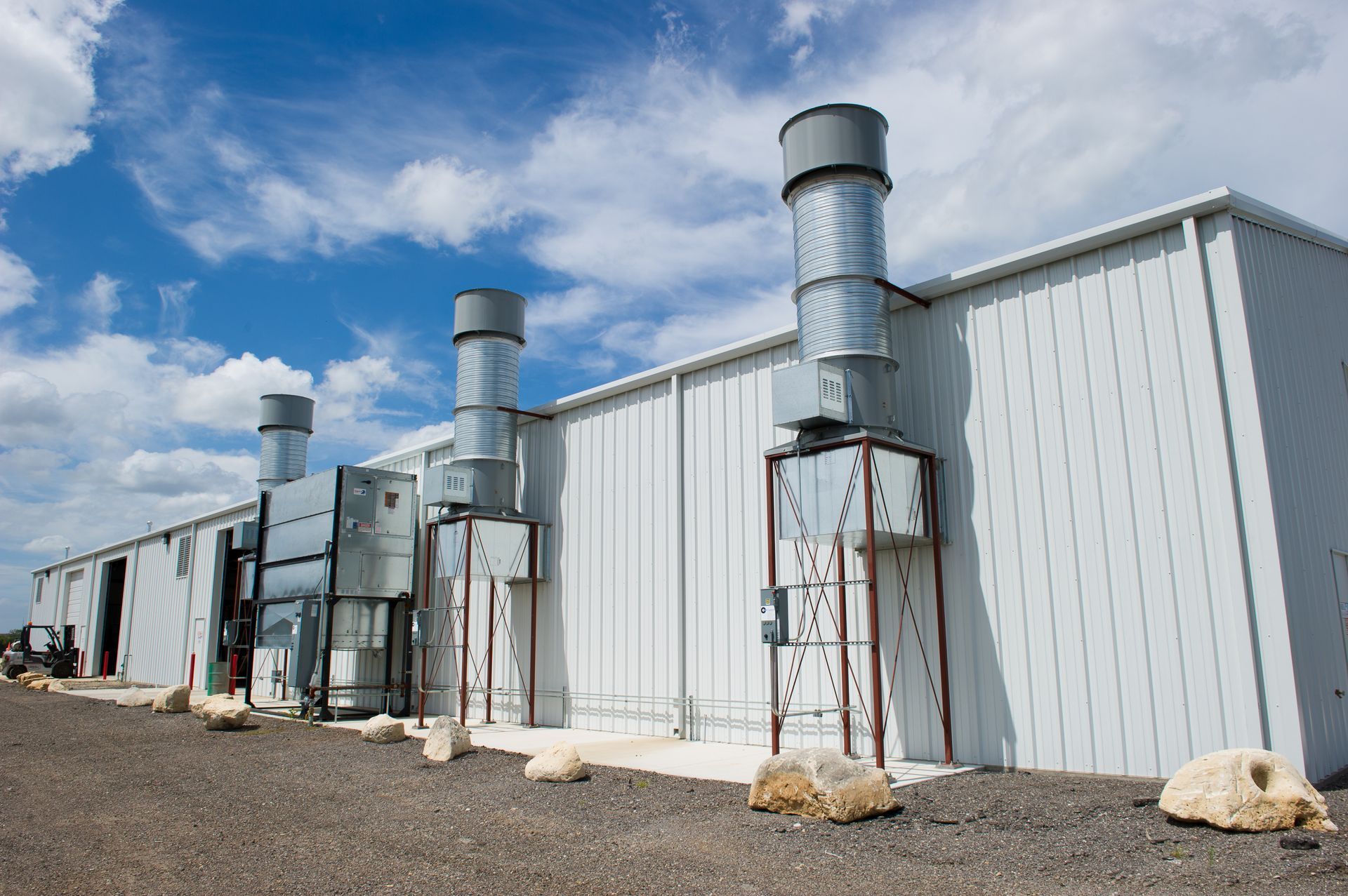 A large white building with a lot of pipes coming out of it