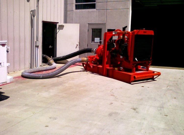 A red machine with a hose attached to it