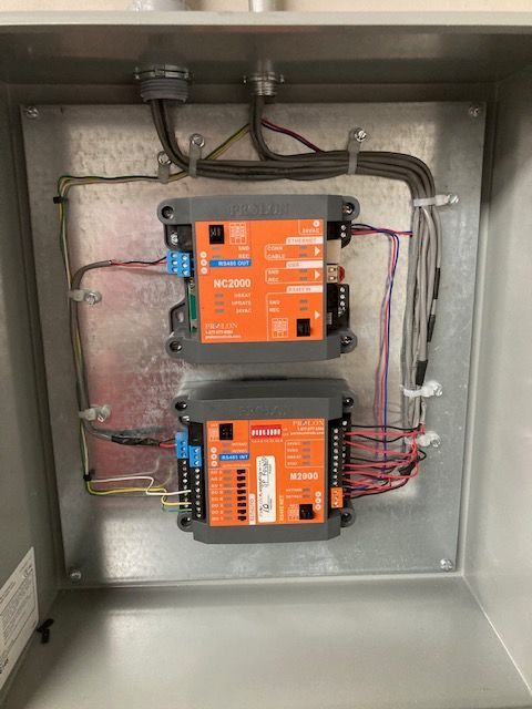 A metal box with two orange boxes inside of it.