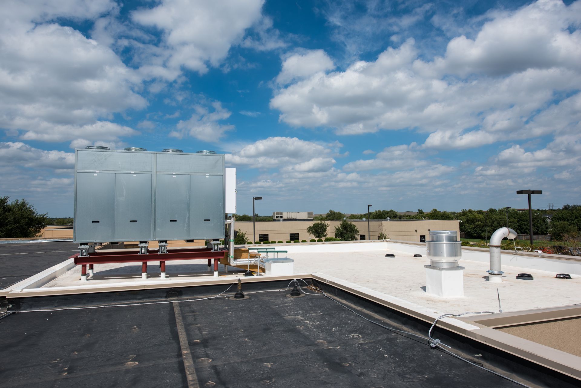 The roof of a building with a blue sky in the background