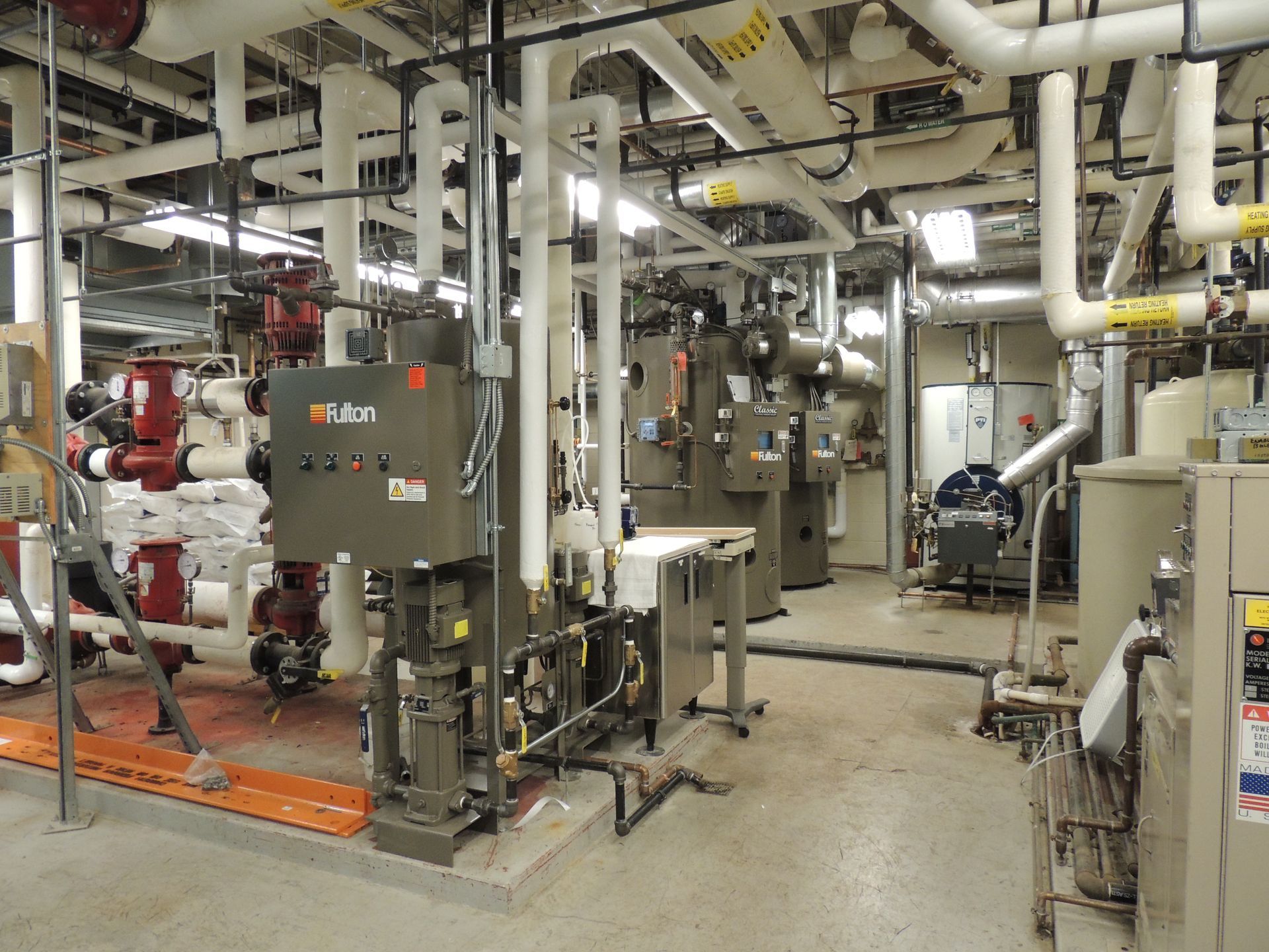 A large room with lots of pipes and a box that says ' sutton ' on it