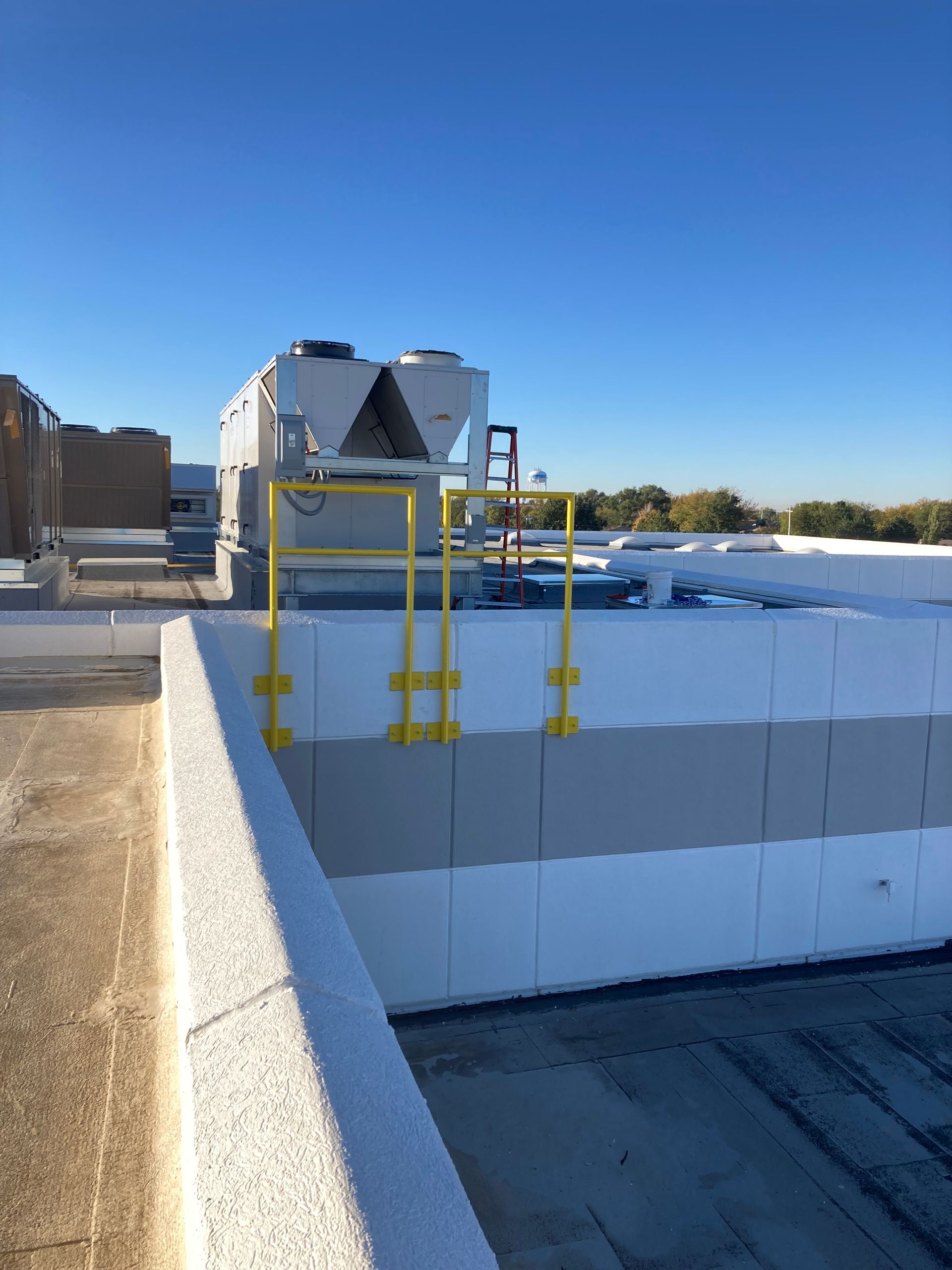 A yellow railing on the side of a building