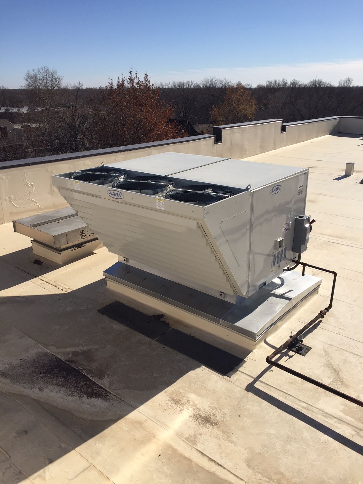 A large white box is sitting on top of a roof.