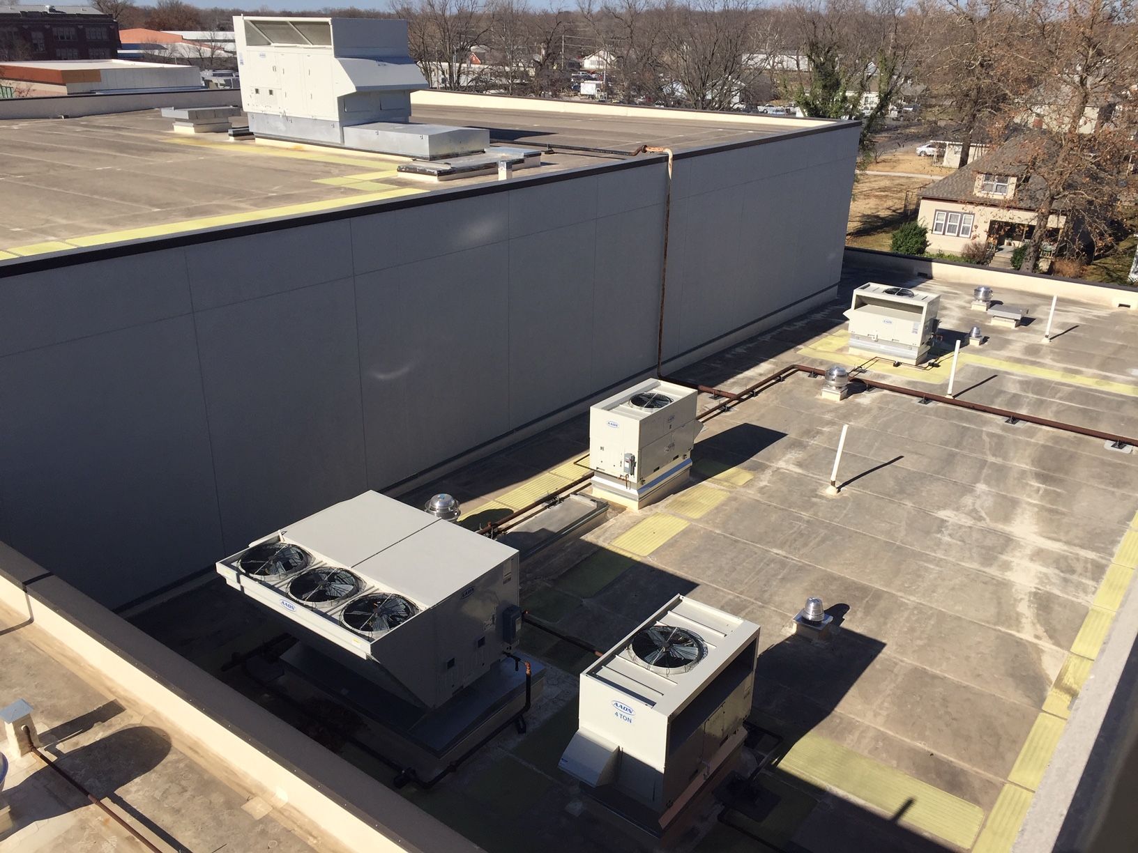 The roof of a building with a lot of air conditioning equipment on it.