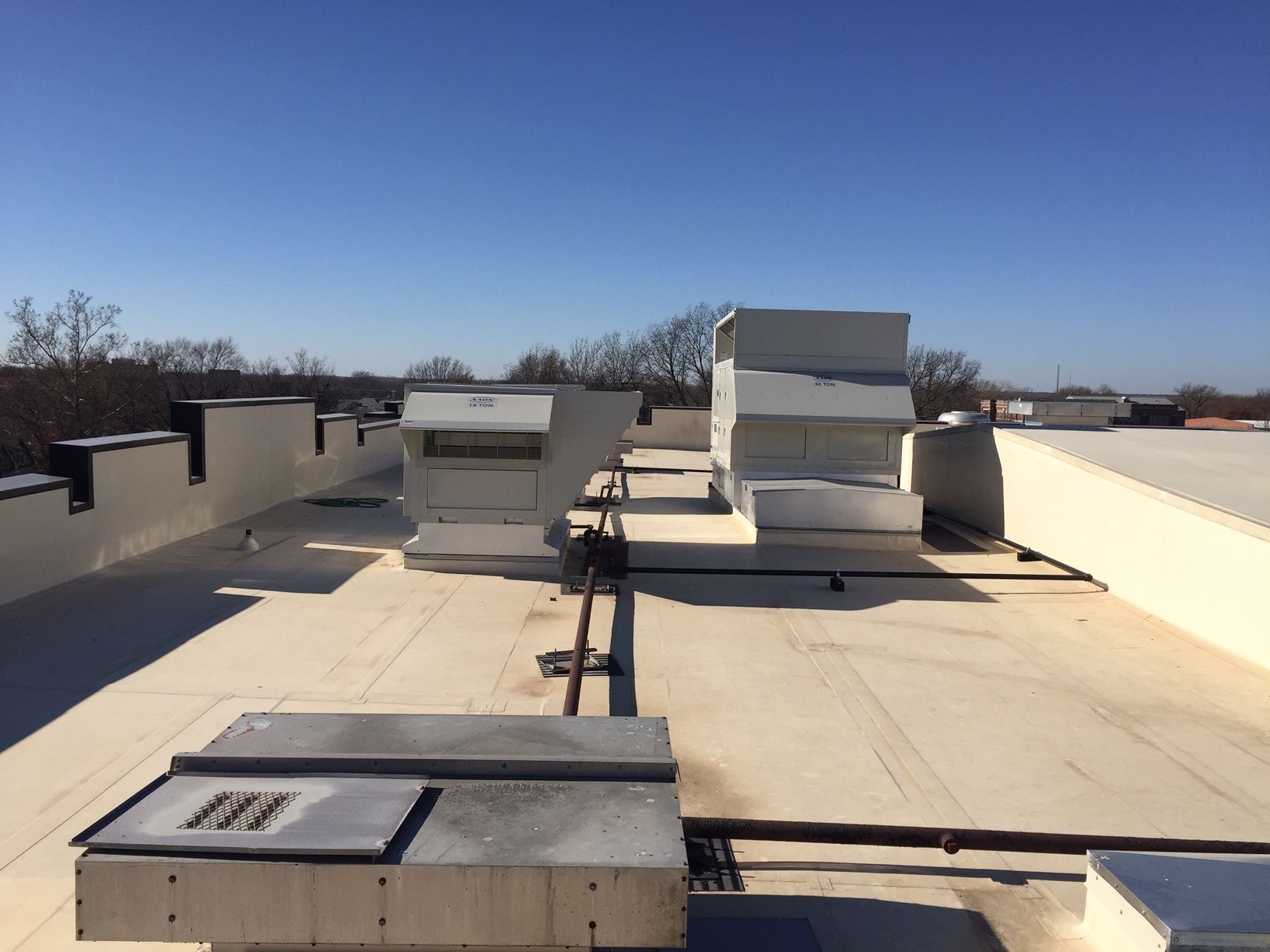 The roof of a building with a blue sky in the background