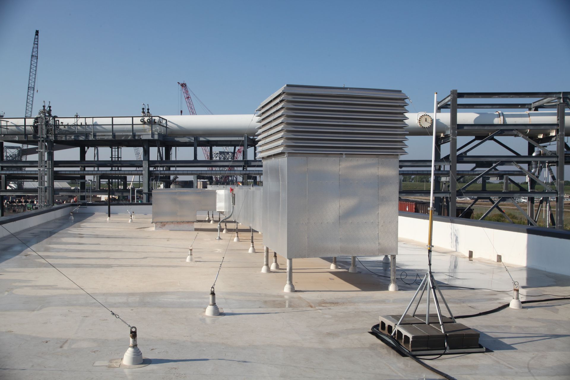 A rooftop with a lot of pipes on it