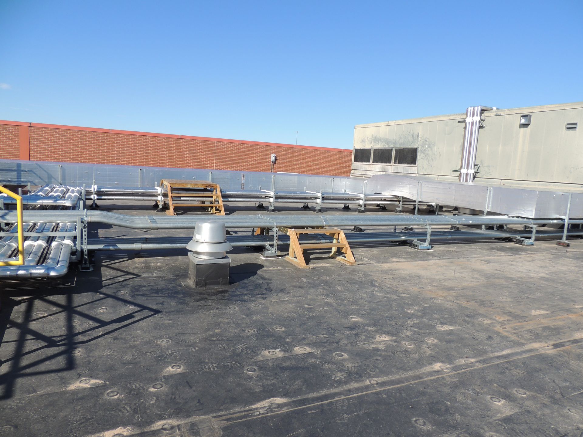 The roof of a building with a lot of pipes on it