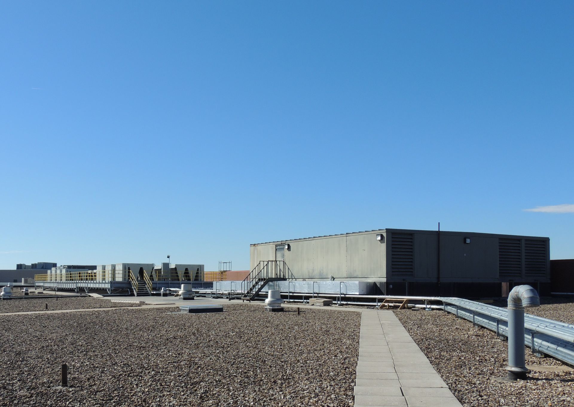 A rooftop of a building with a blue sky in the background