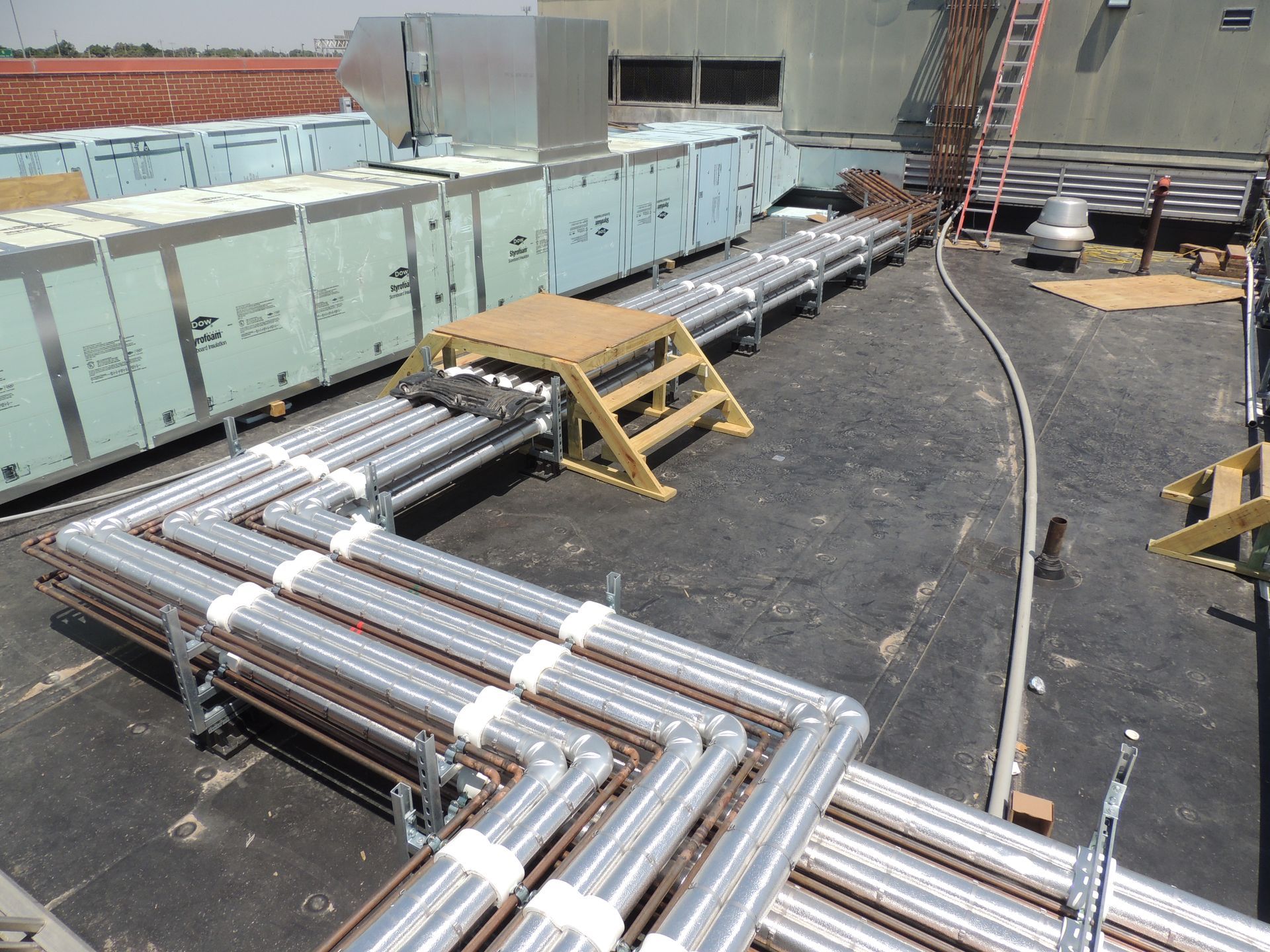 A bunch of pipes are lined up on a roof