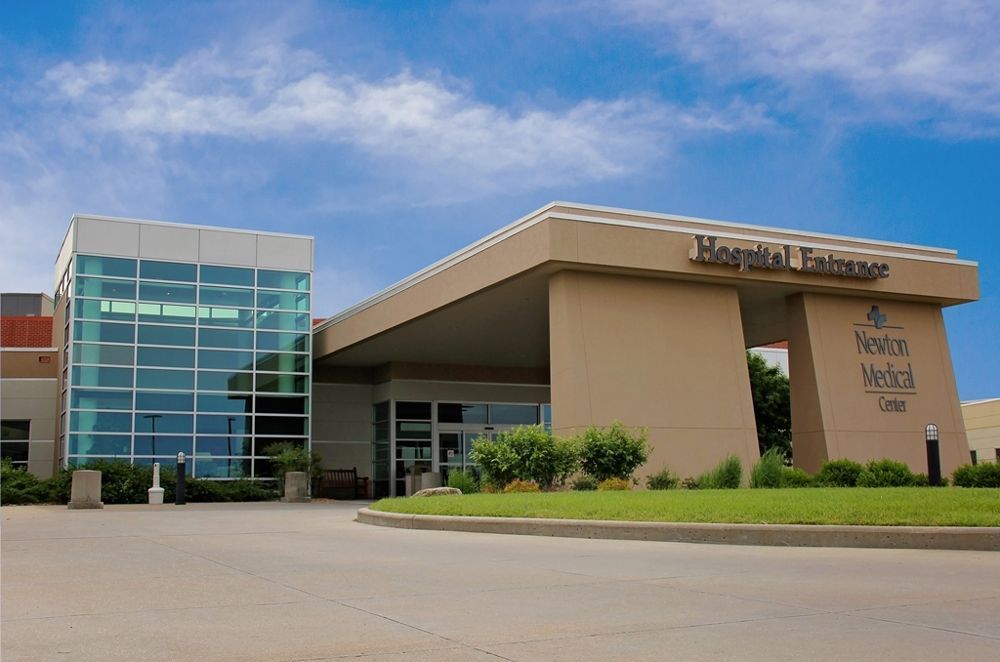 A hospital entrance with a blue sky in the background