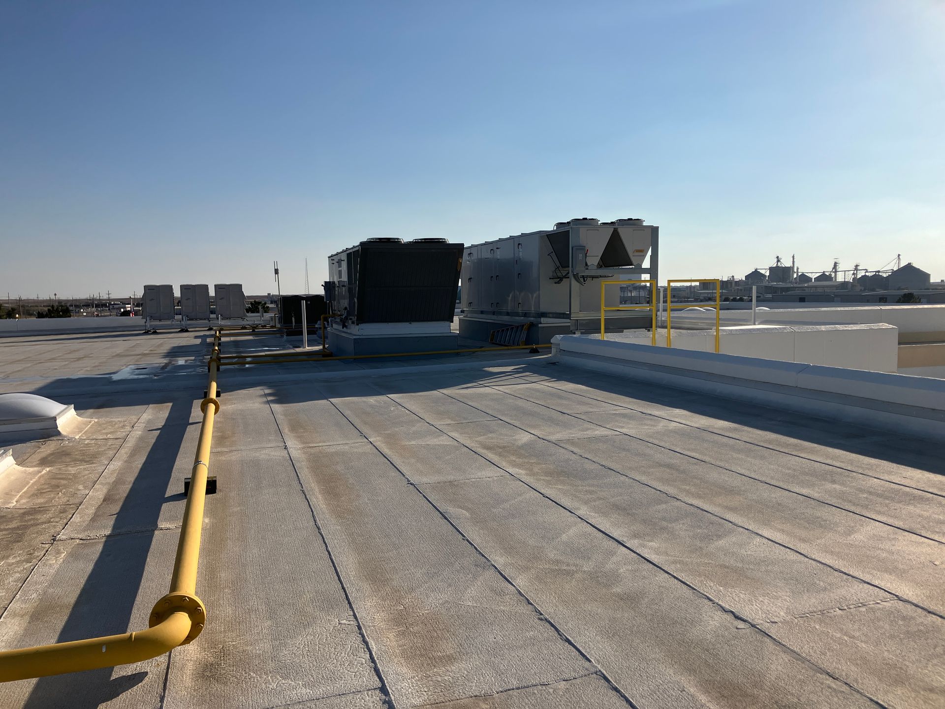 The roof of a building with a lot of pipes on it.