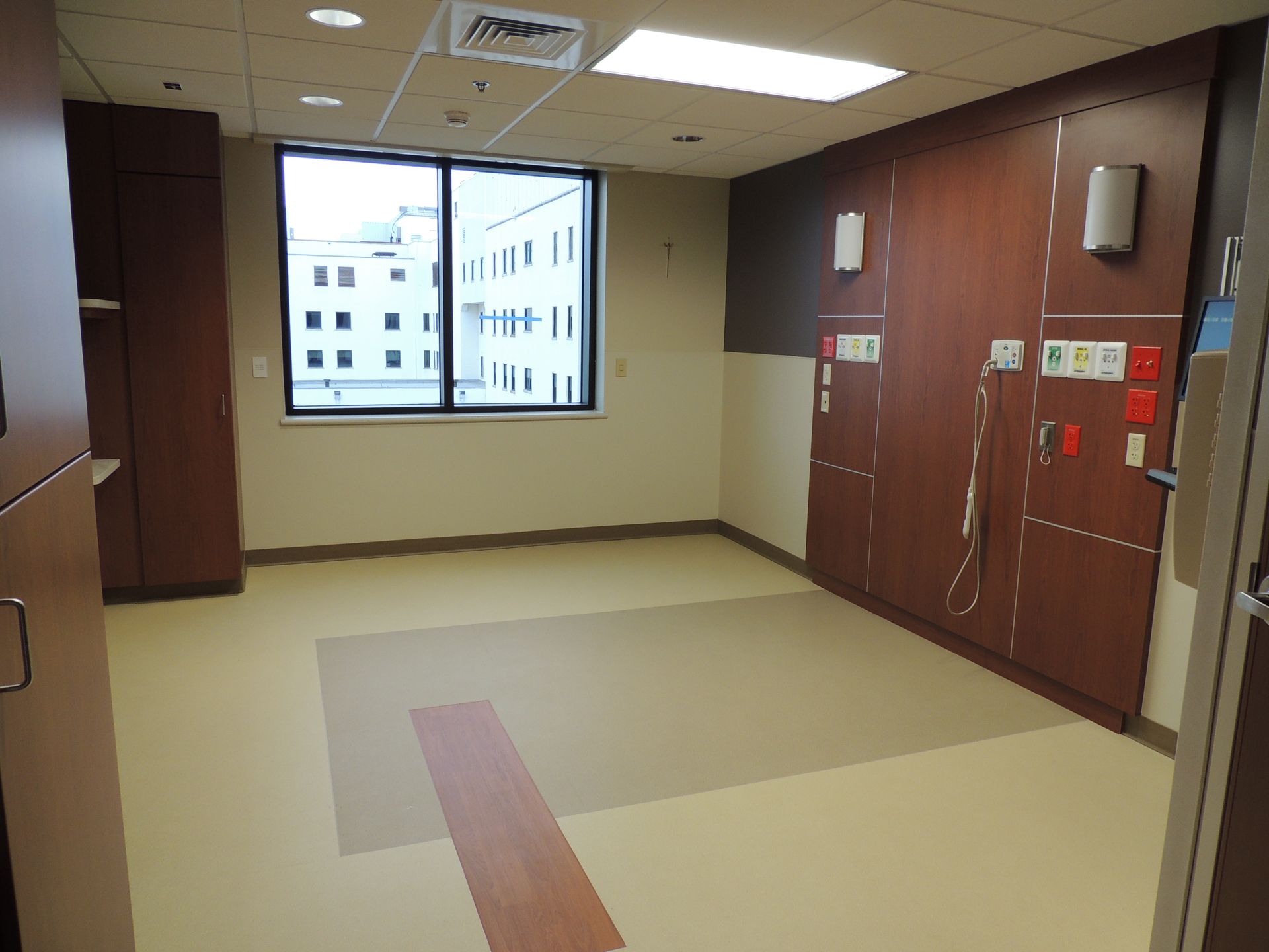 An empty hospital room with a large window