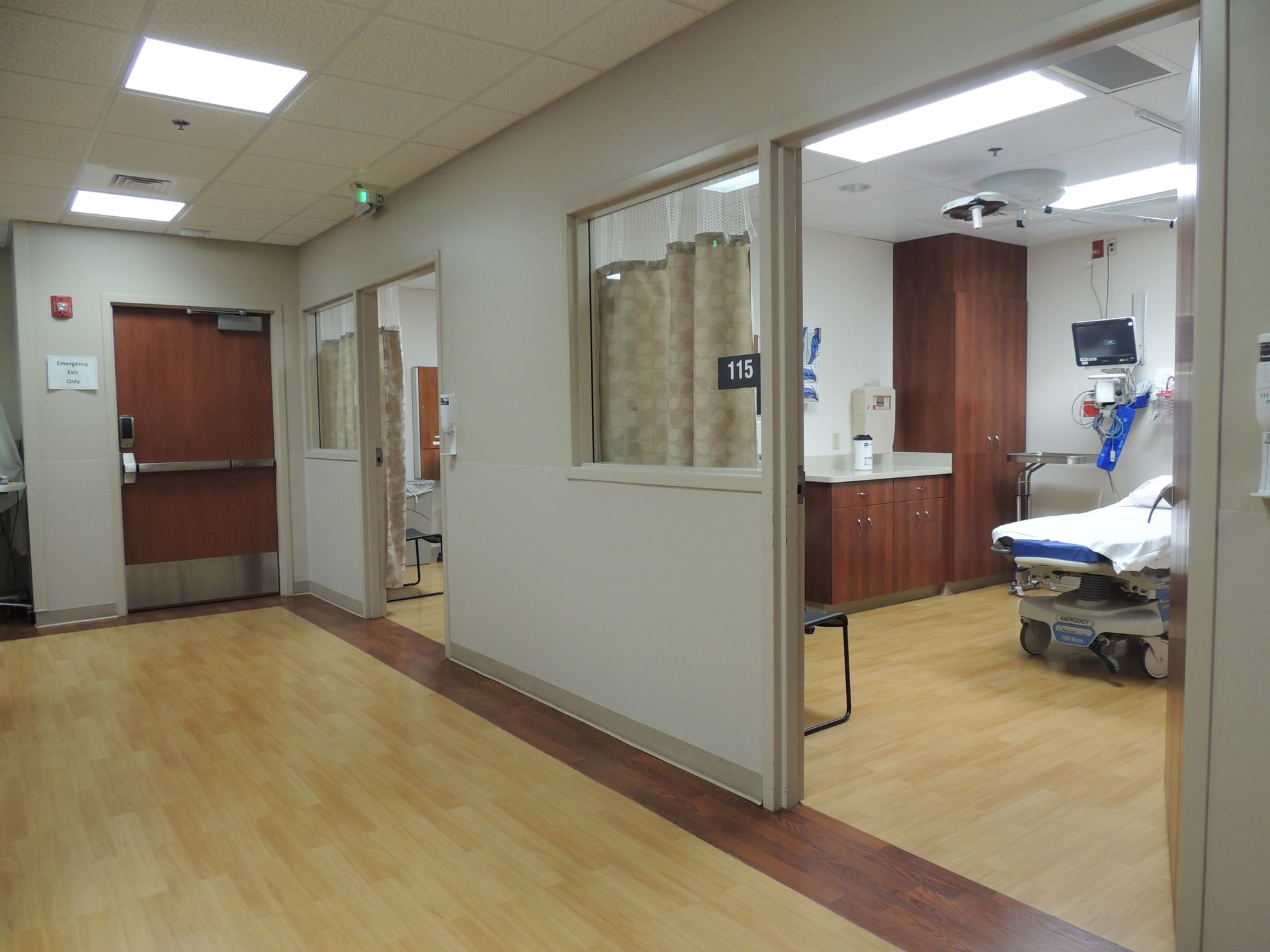 A hospital room with a bed and a window.