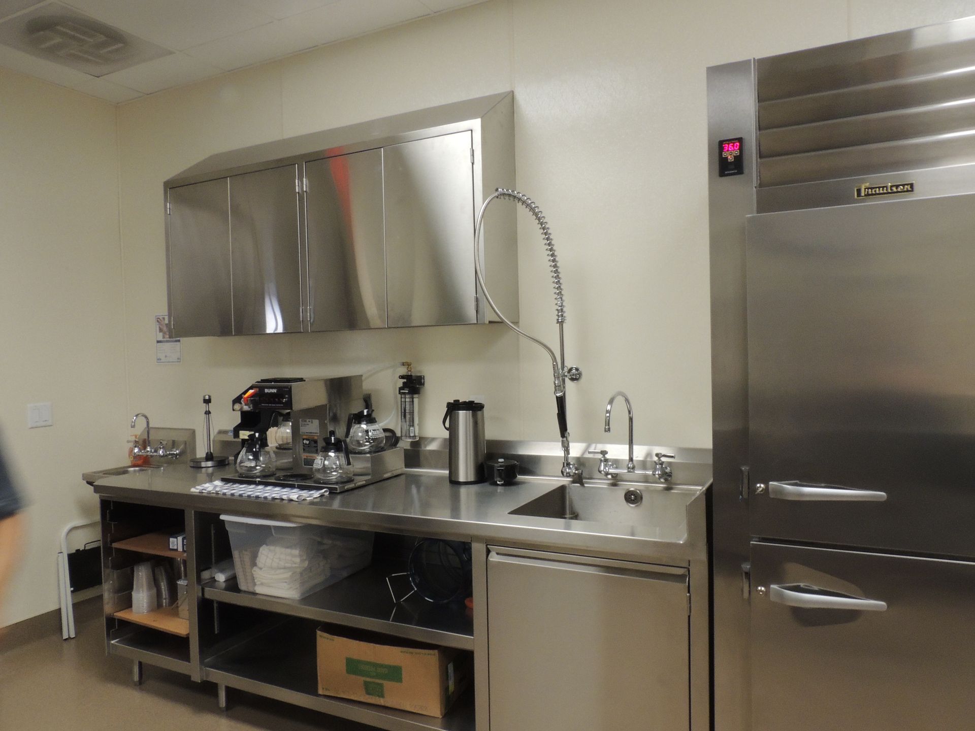 A kitchen with stainless steel appliances and a lg refrigerator