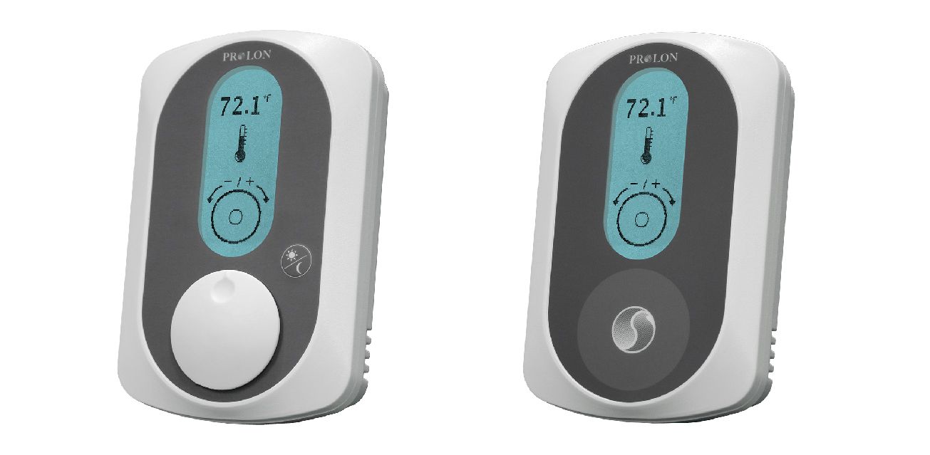 Two thermostats are sitting next to each other on a white background.