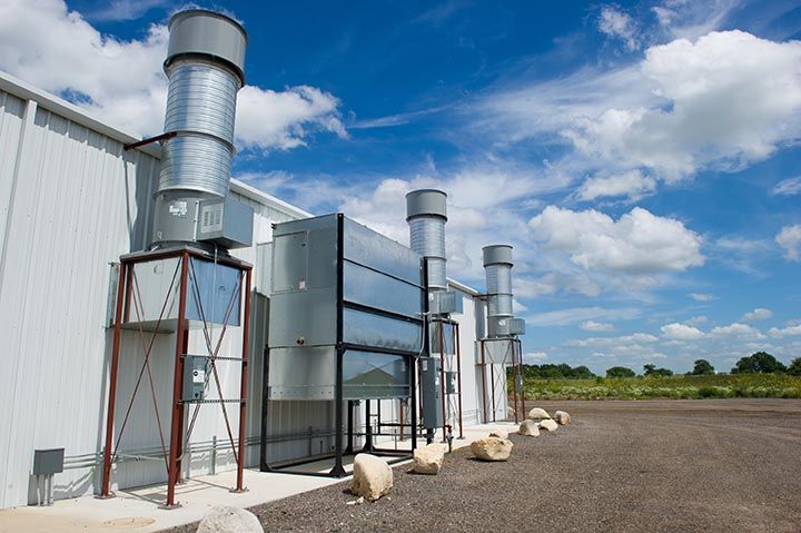 A building with a lot of pipes coming out of it.