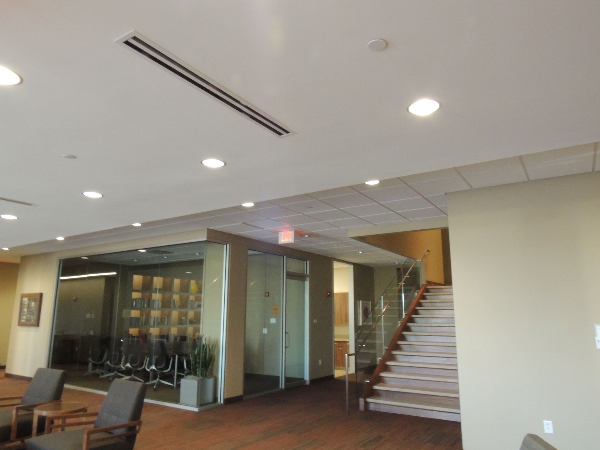 A large room with stairs leading up to a conference room