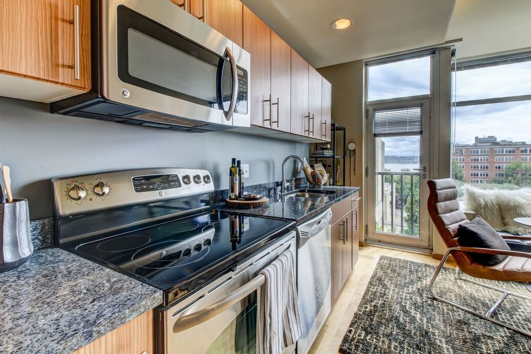 A kitchen with stainless steel appliances and granite counter tops.