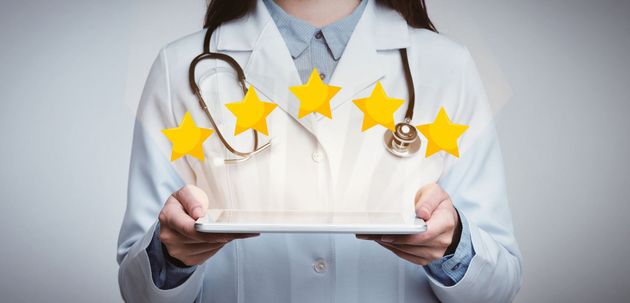 picture of a doctor holding a tablet with five stars over it