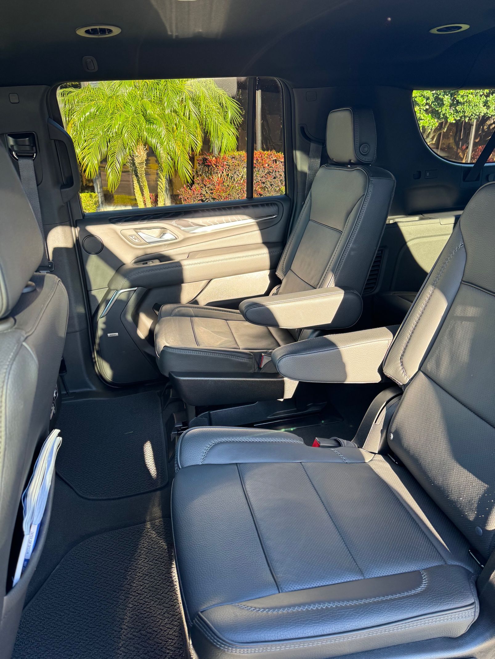Interior of a car with gray leather seats; the middle row has two captain's chairs.