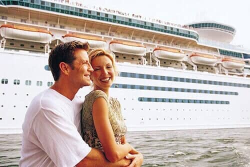 Embracing couple in front of cruise ship — Corporate Limousine Service in Tampa, FL
