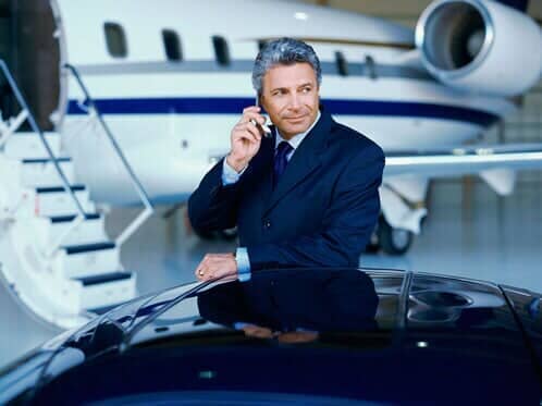 Businessman talking on a phone — Corporate Limousine Service in Tampa, FL