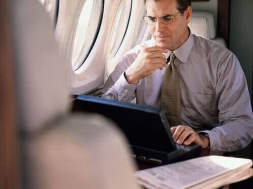 Businessman sitting on an airplane — Corporate Limousine Service in Tampa, FL