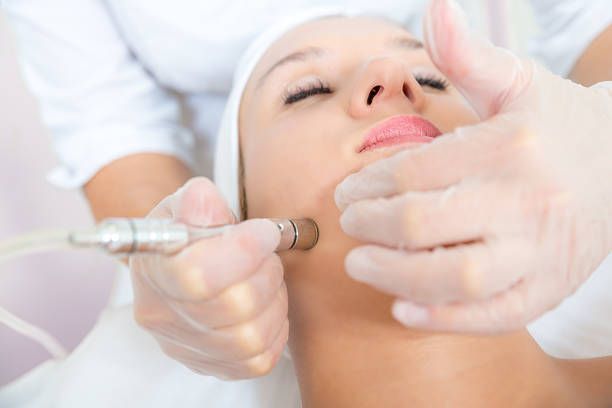 A woman is getting a facial treatment at a beauty salon.