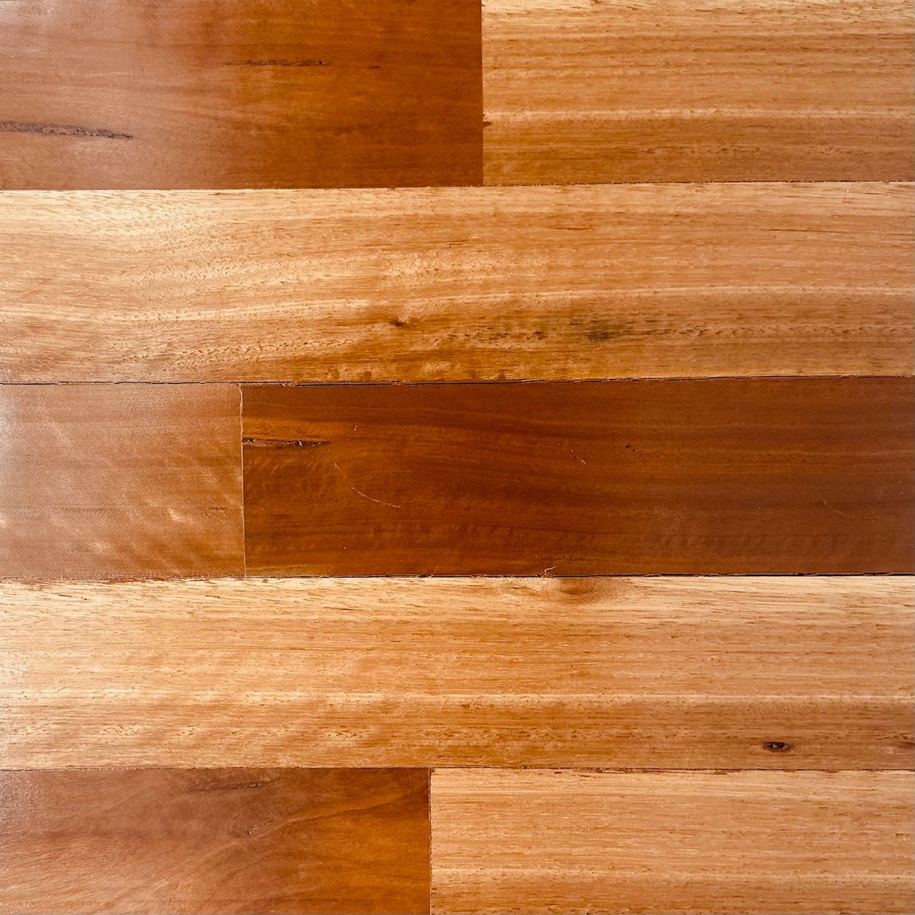 A close up of a wooden floor with a diagonal pattern.