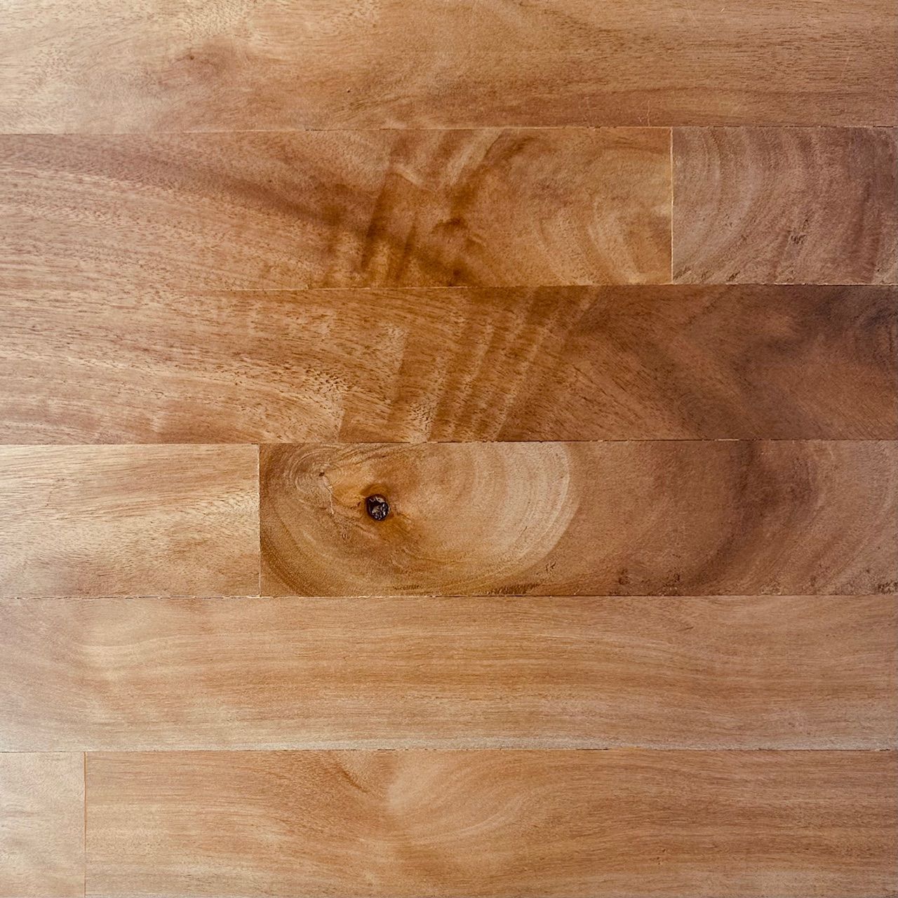 A close up of a piece of wood with a screw in it.