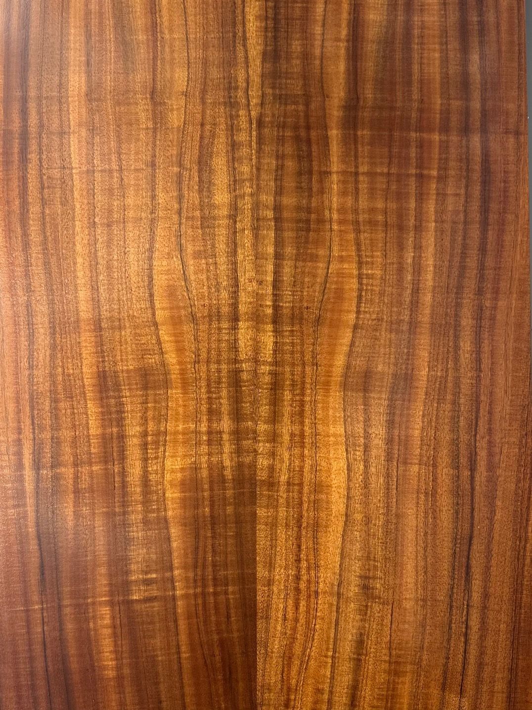 A close up of a piece of wood showing the grain of the wood.