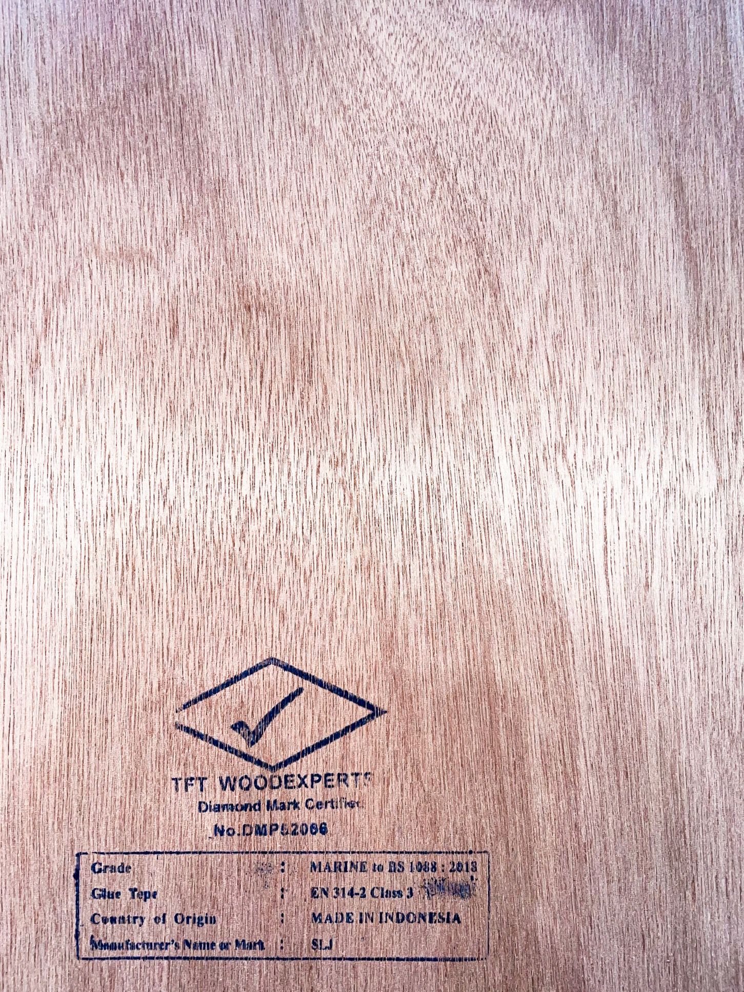 A close up of a piece of wood with a label on it.