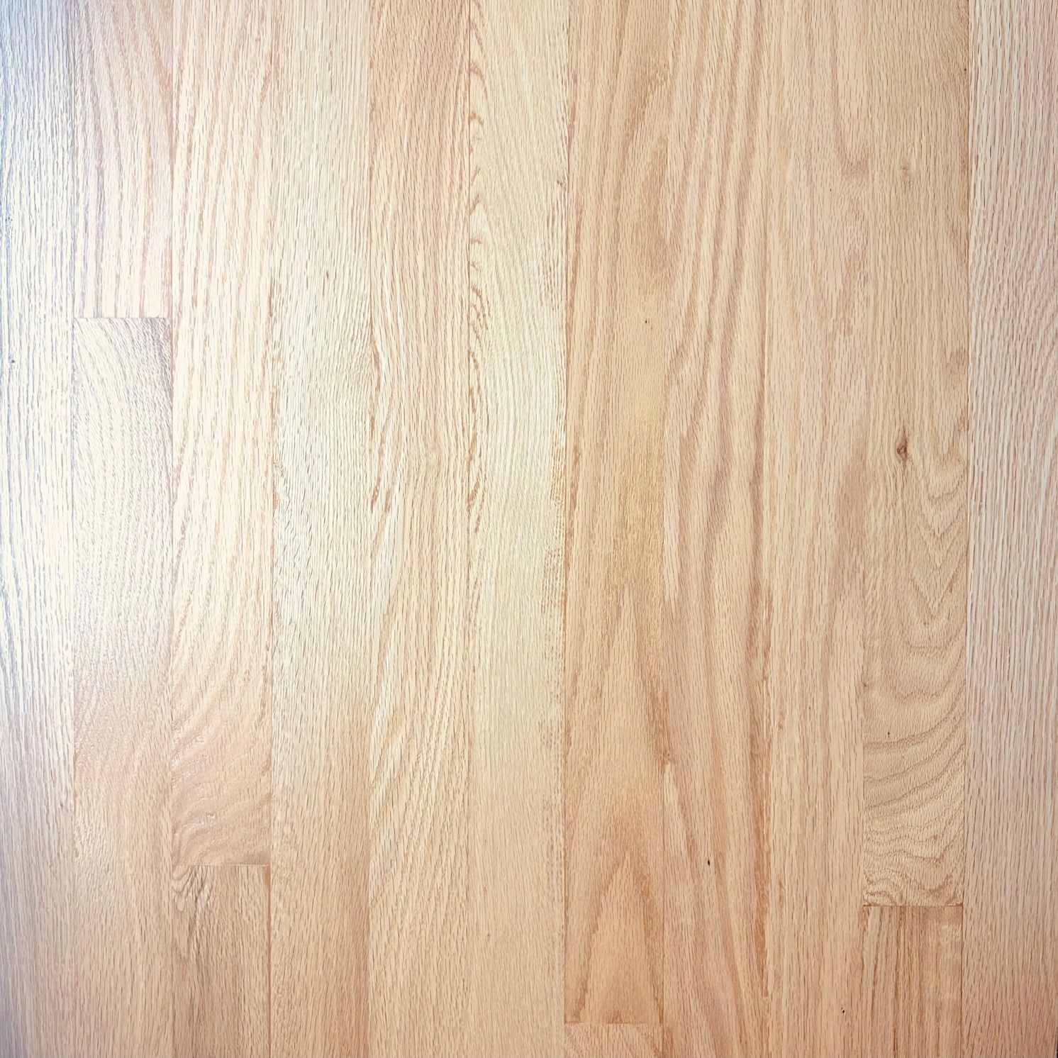 A close up of a light brown wooden floor.