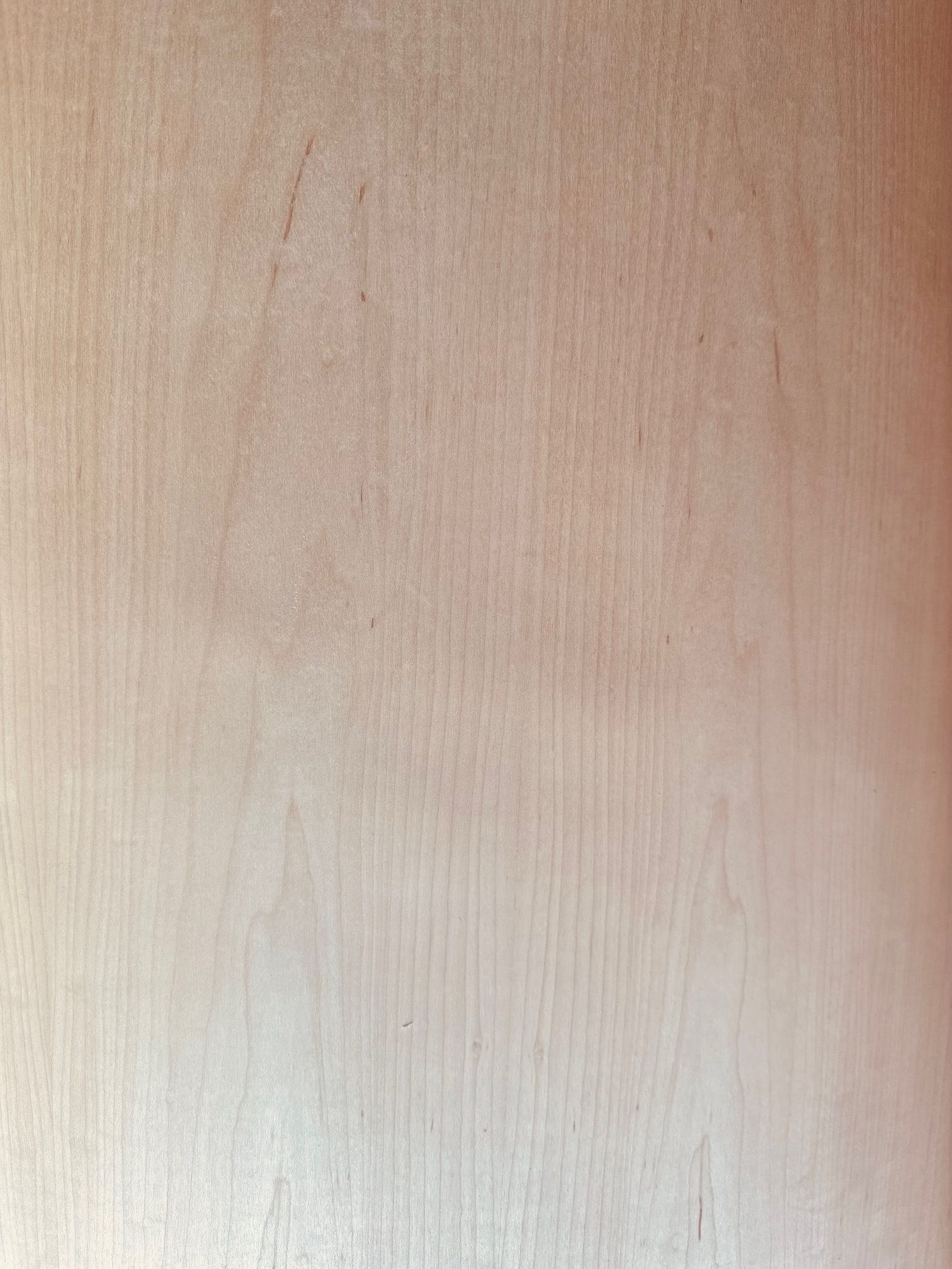 A close up of a piece of wood showing the grain of the wood.