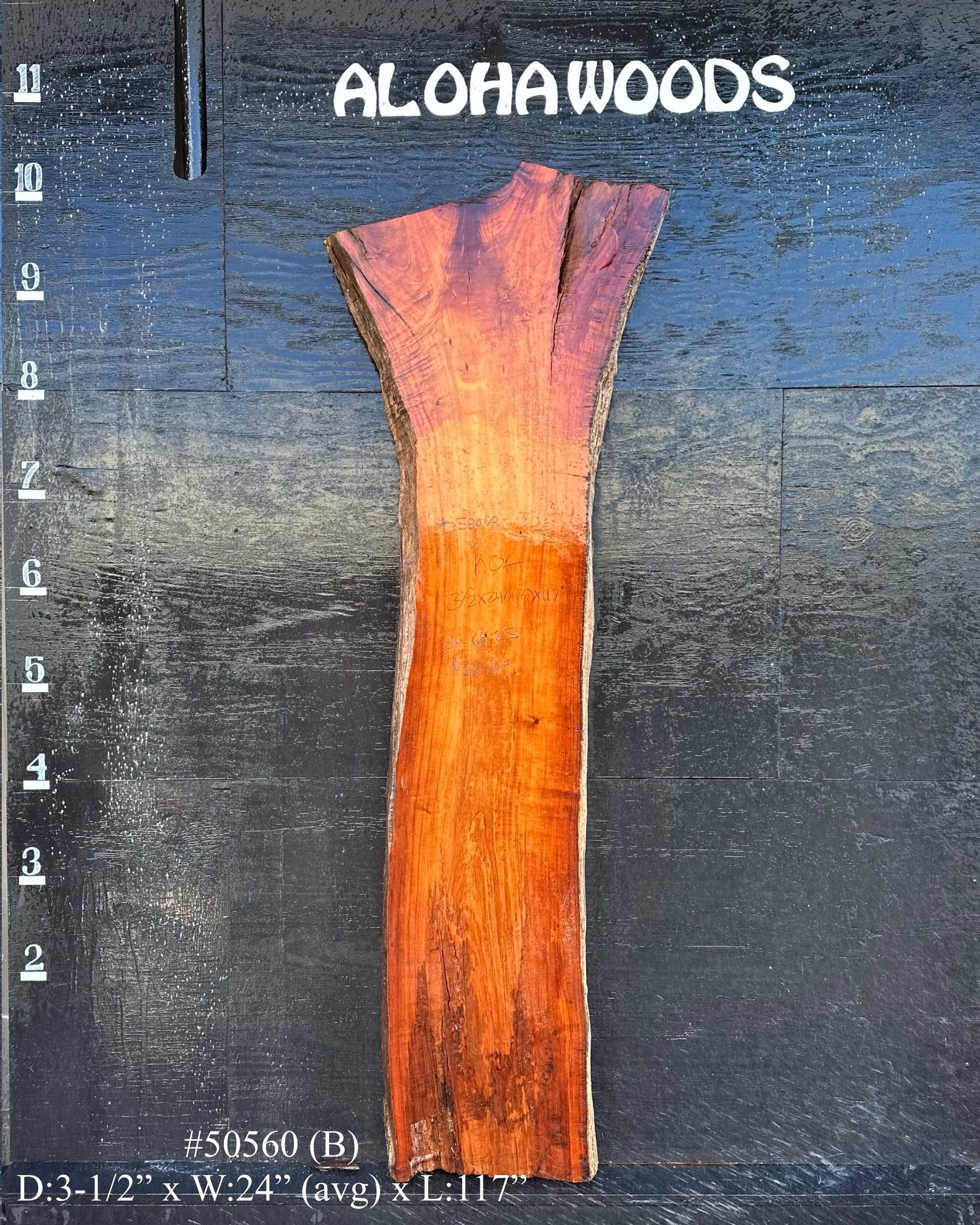 A piece of wood that says aloha woods on it