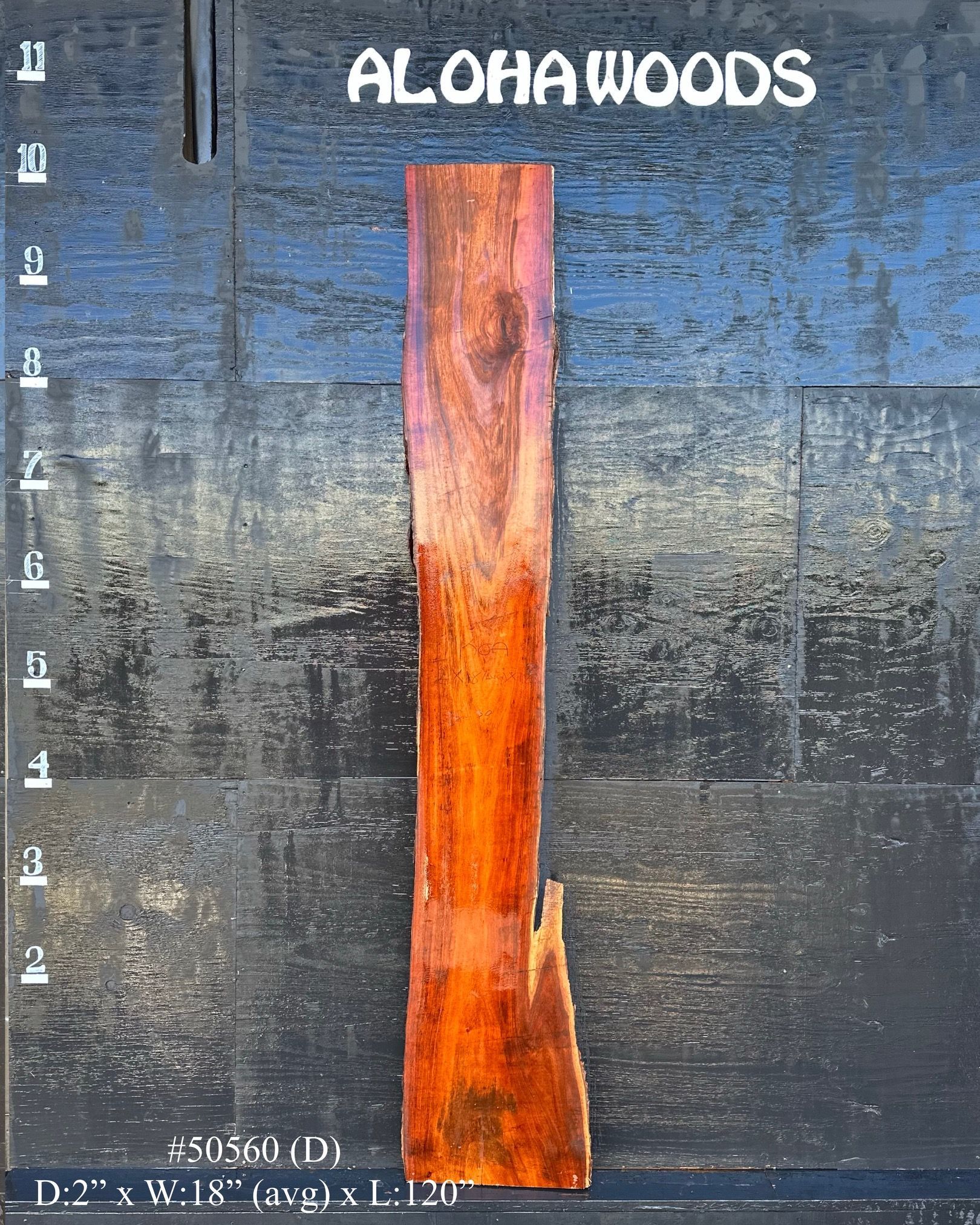 A piece of wood with the word aloha woods on it