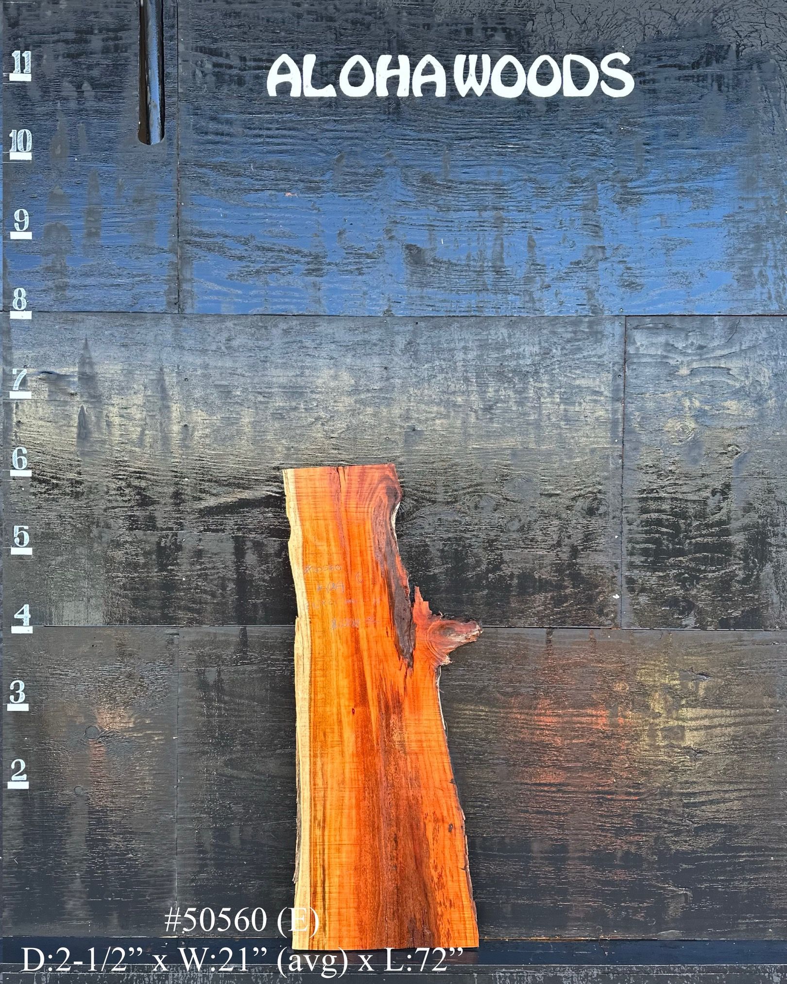 A piece of wood with the words aloha woods on it