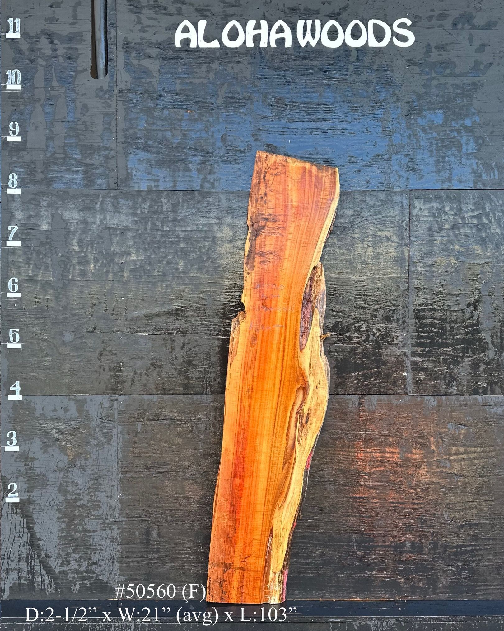 A picture of a piece of wood that says aloha woods