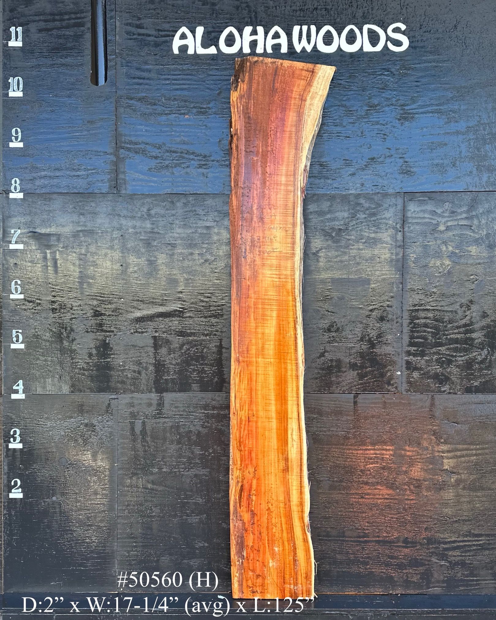 A piece of wood with the words aloha woods on it