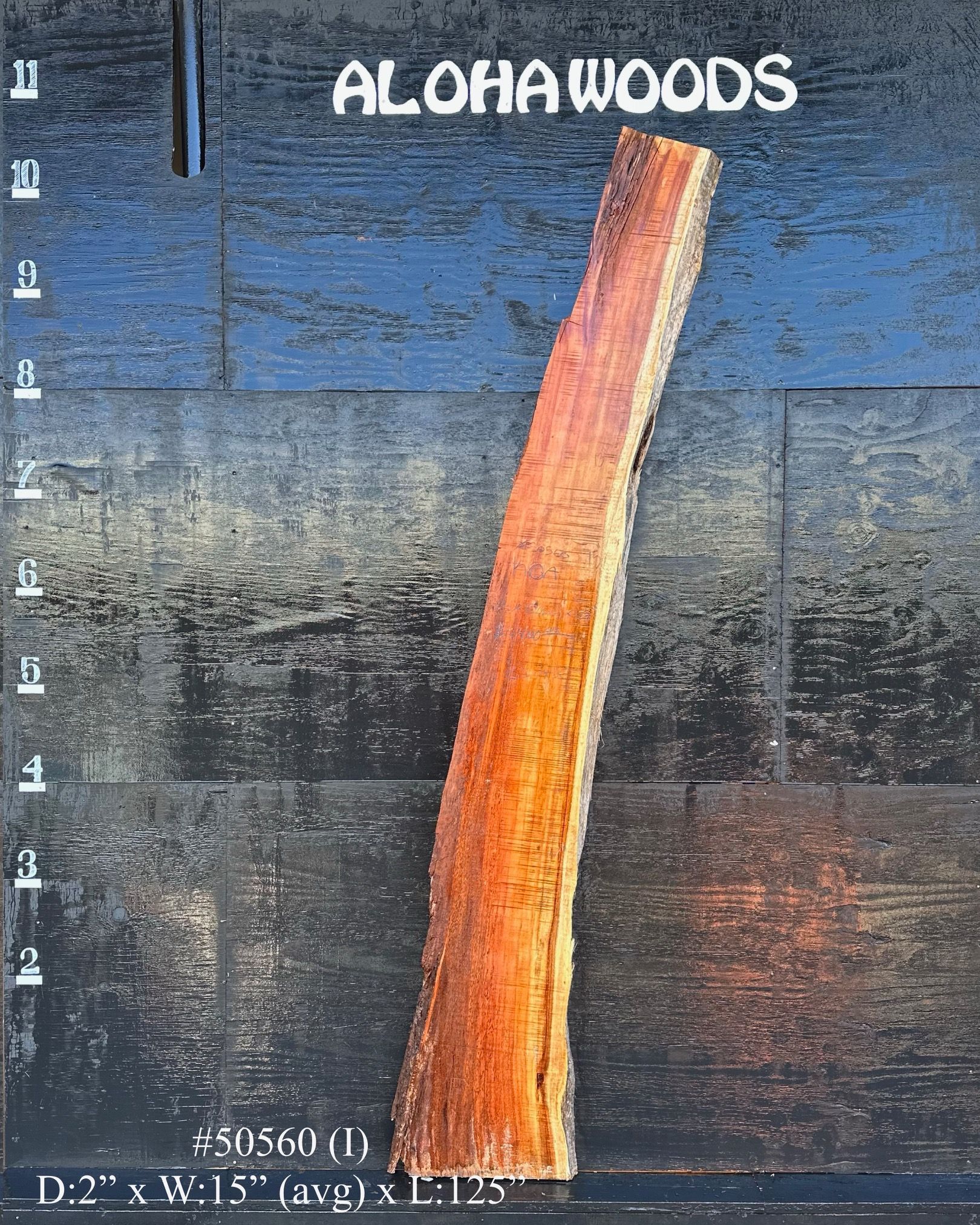 A piece of wood with the word aloha woods on it