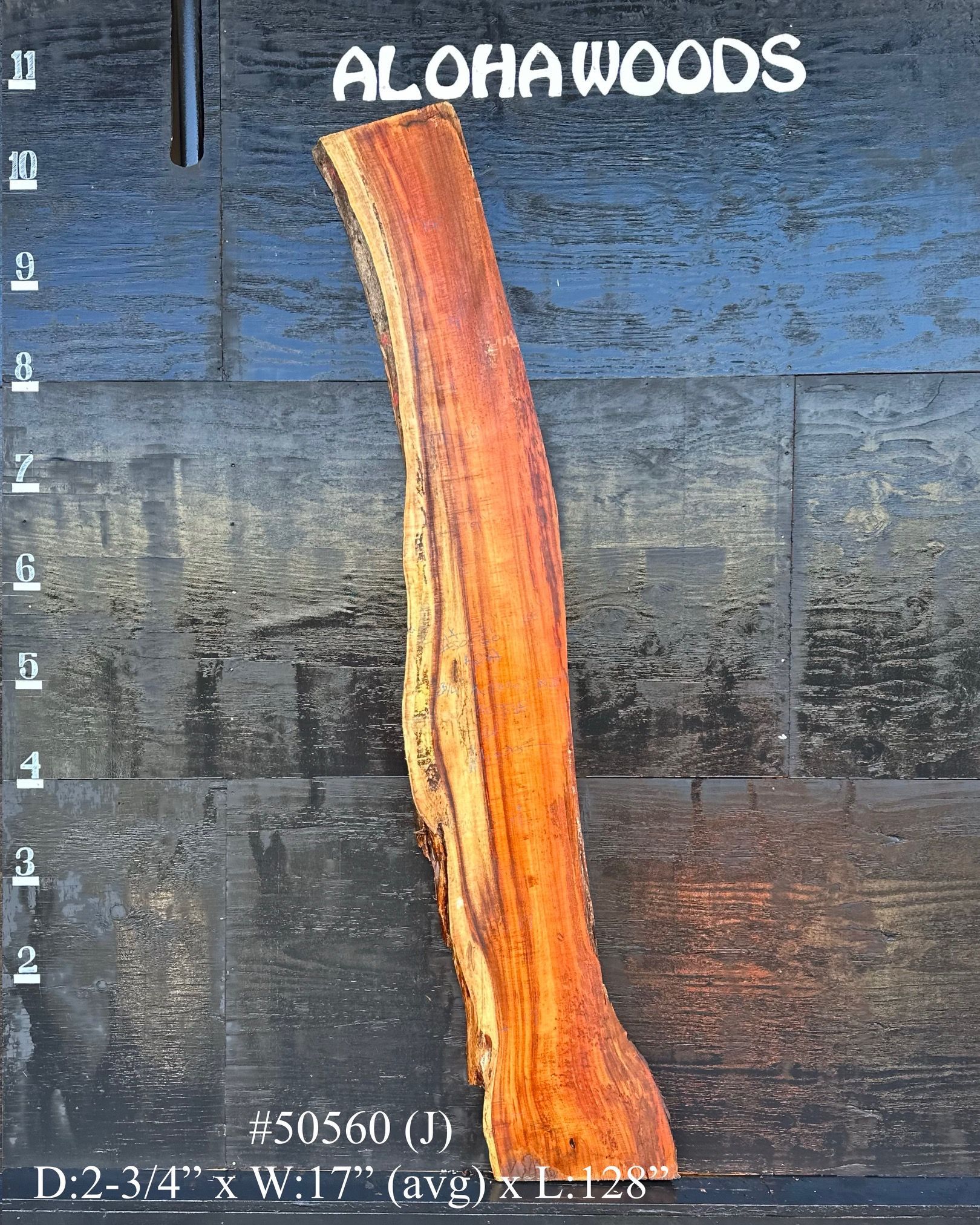 A piece of wood with the word aloha woods on it