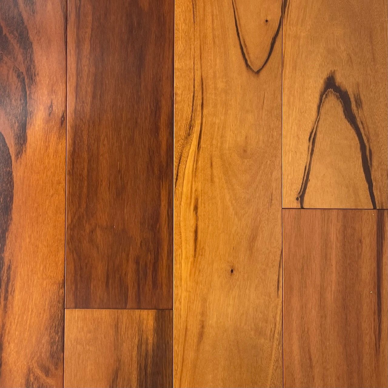 A close up of a wooden floor with a few spots on it