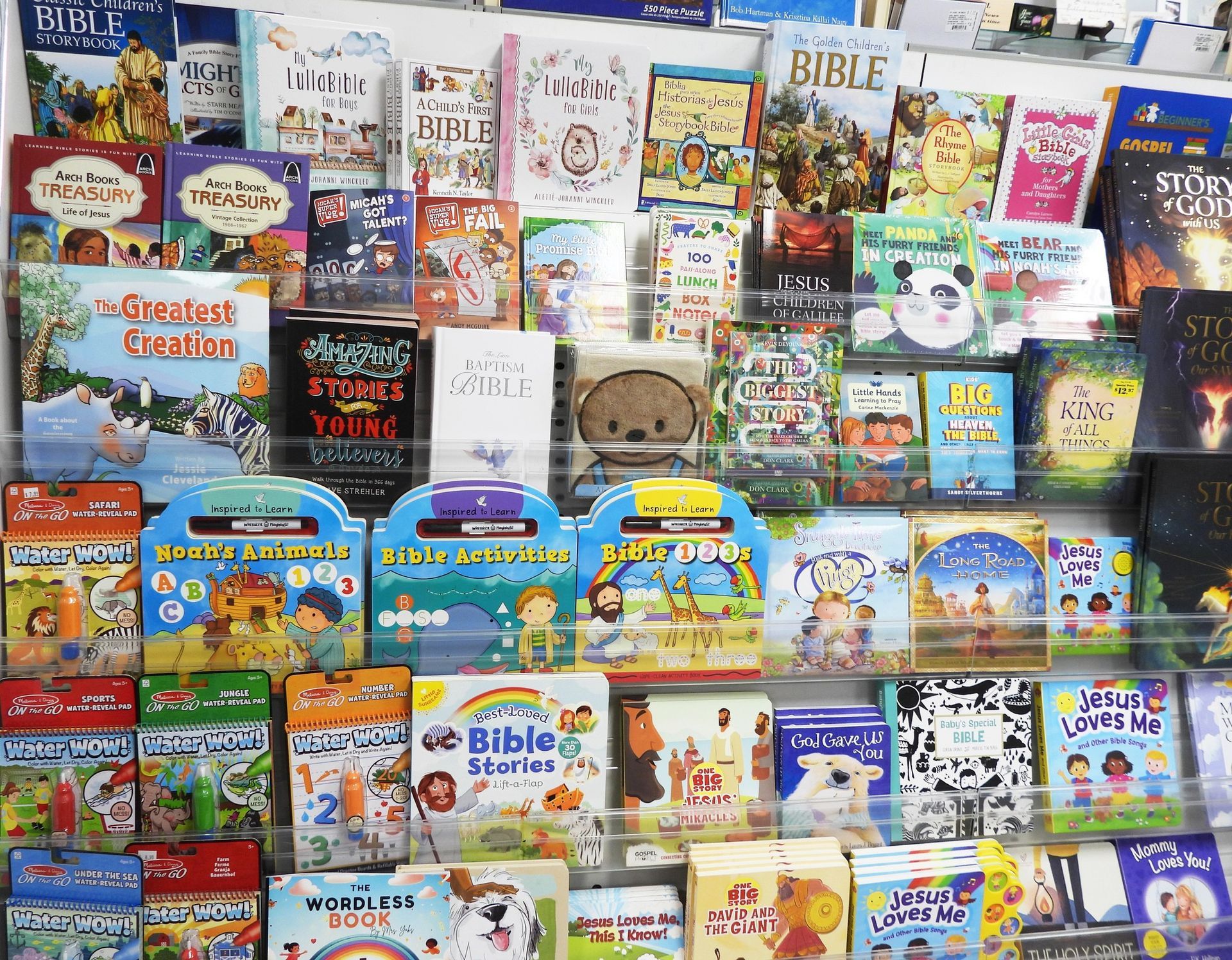 Books on display, mostly children's, with colorful covers; shop setting.