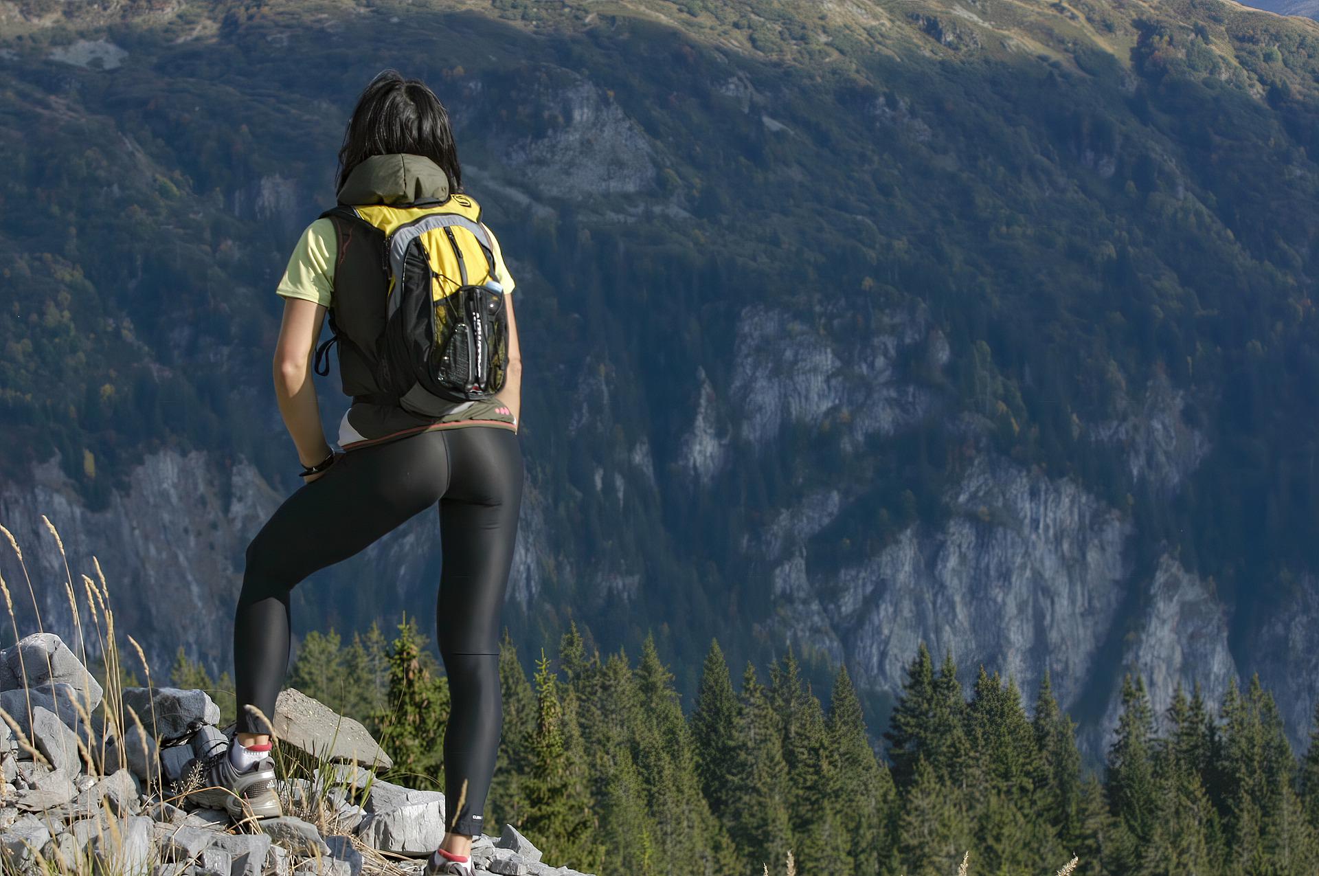 Hiker standing on ridge link reads 
