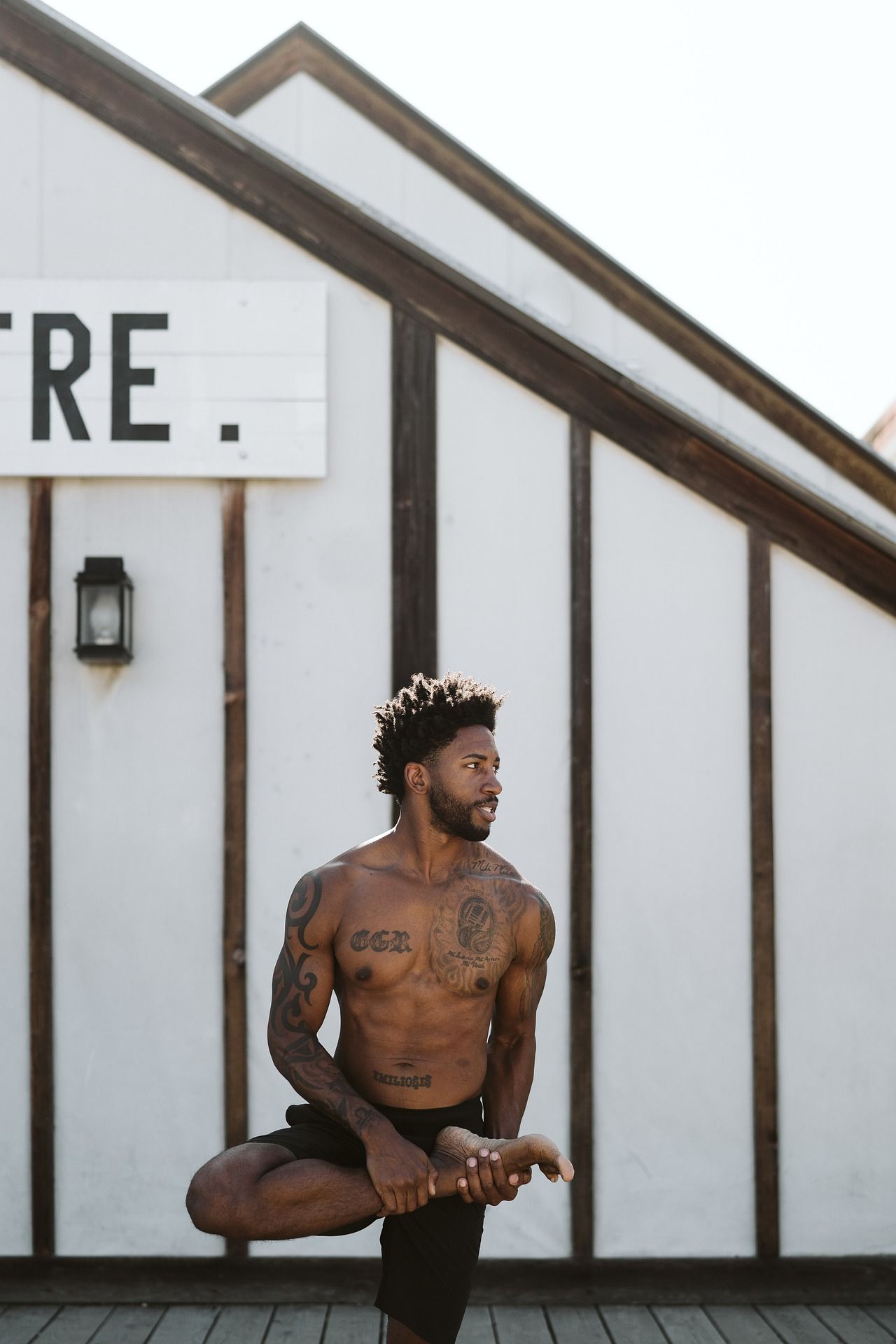 man stretching in tree yoga pose