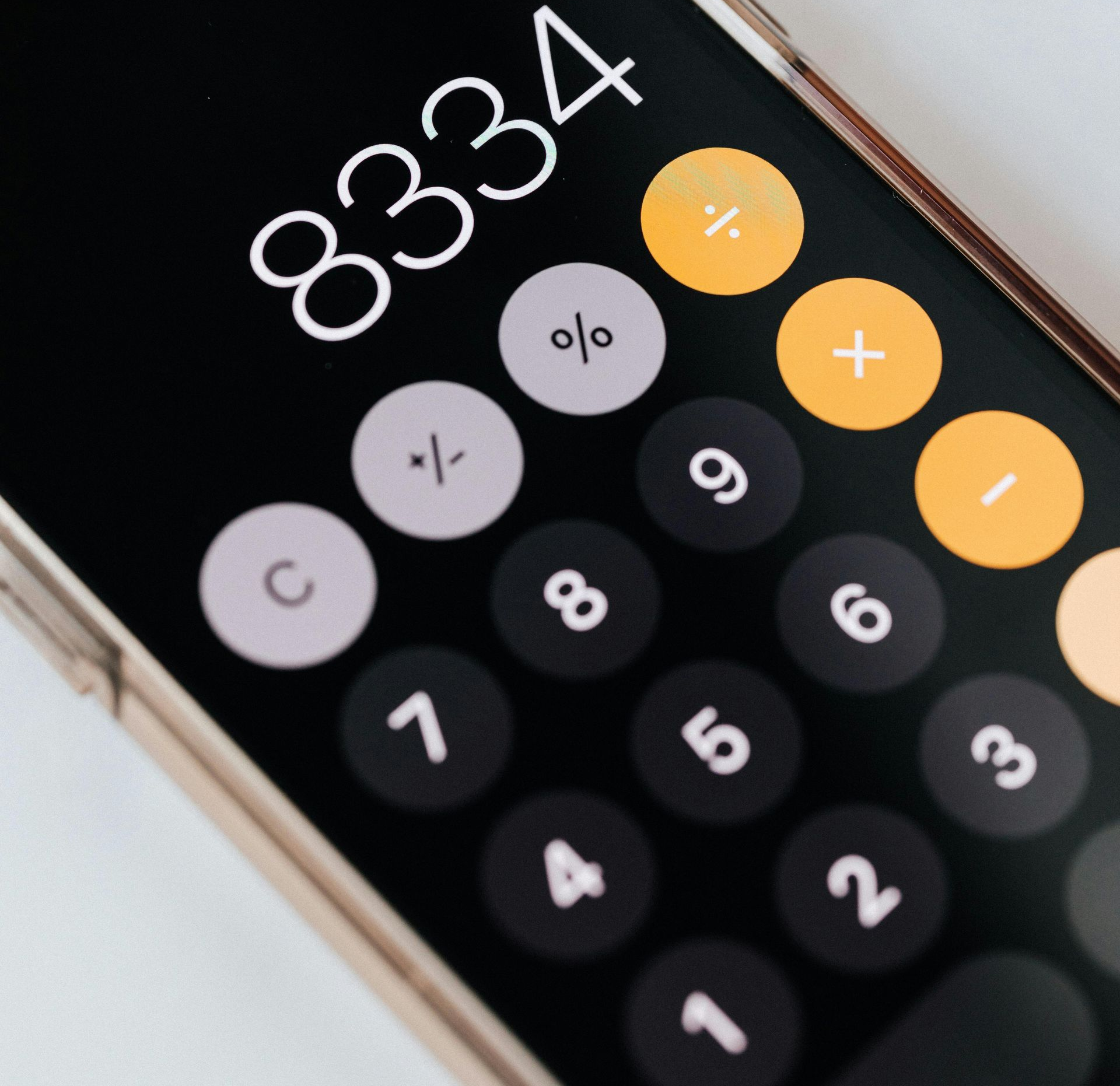 White and beige electric scooter parked on a pink background.